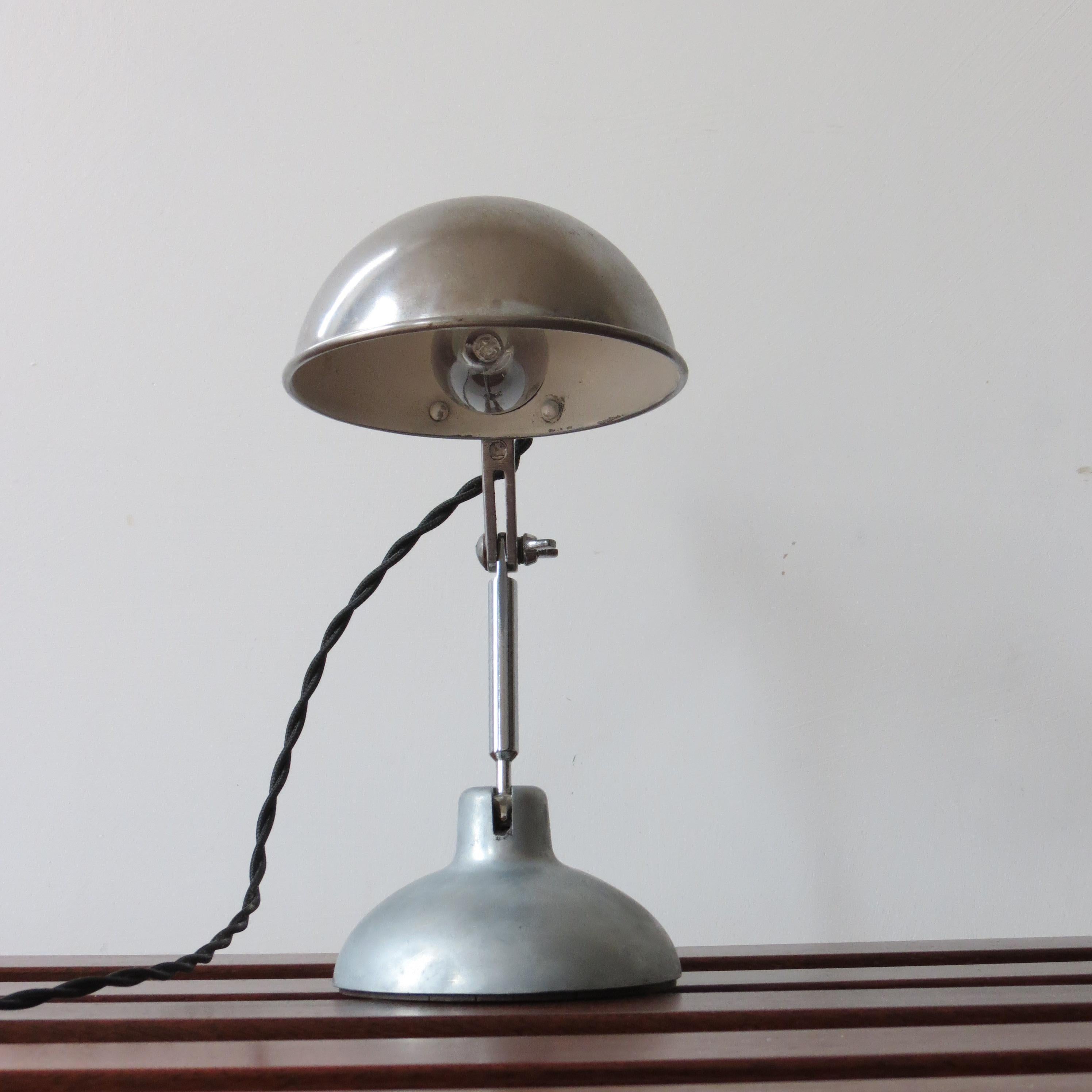 Wonderful desk lamp by Metek England from the 1950s. Made from polished aluminum with steel rod upright, Bakelite lamp fitting, newly rewired. Designed originally as a travel lamp, its fully maneuverable to many different positions and it retains