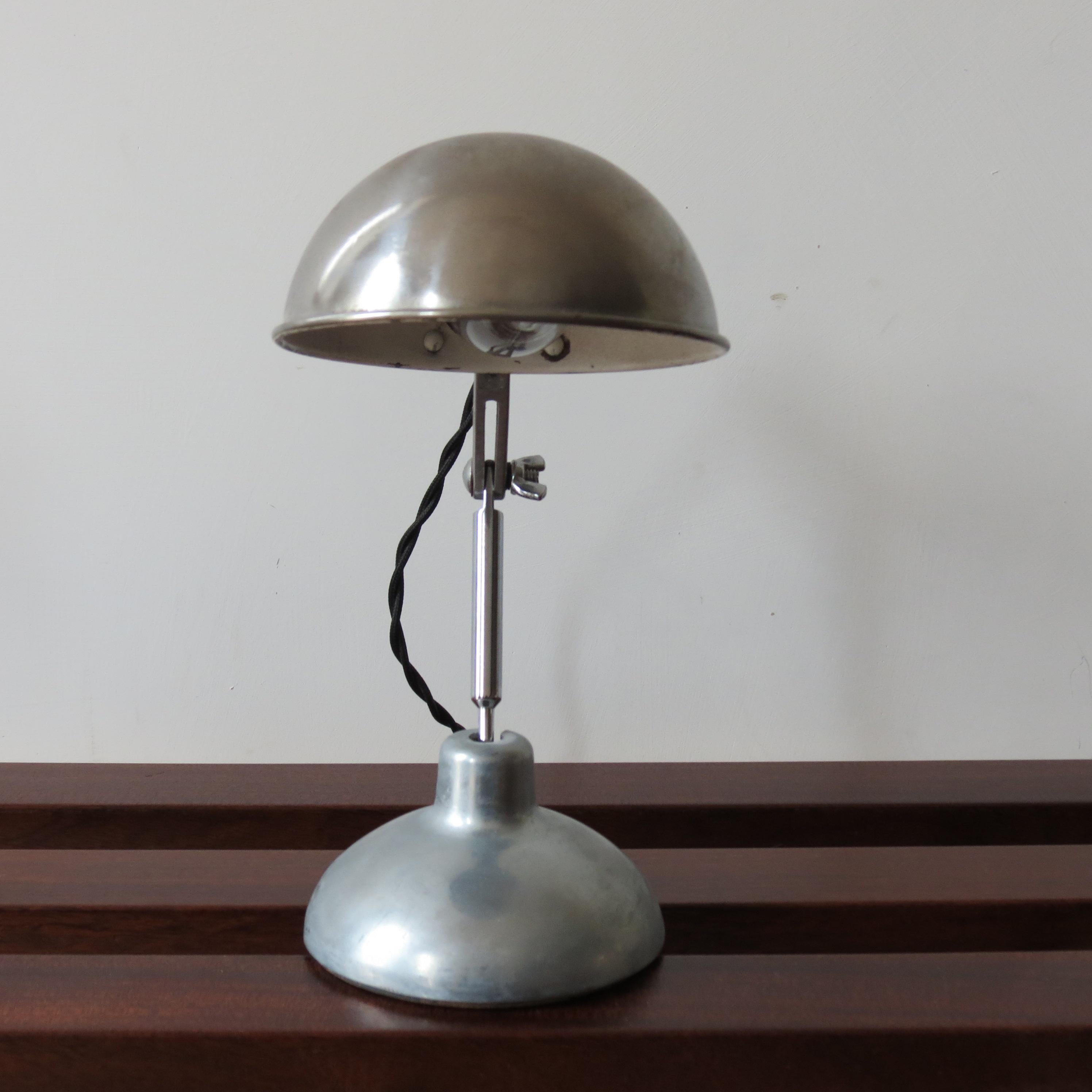 Wonderful desk lamp by Metek England from the 1950s. Made from polished aluminium with steel rod upright, bakelite lamp fitting, newly rewired. Designed originally as a travel lamp, its fully manoeuvrable to many different positions and it retains