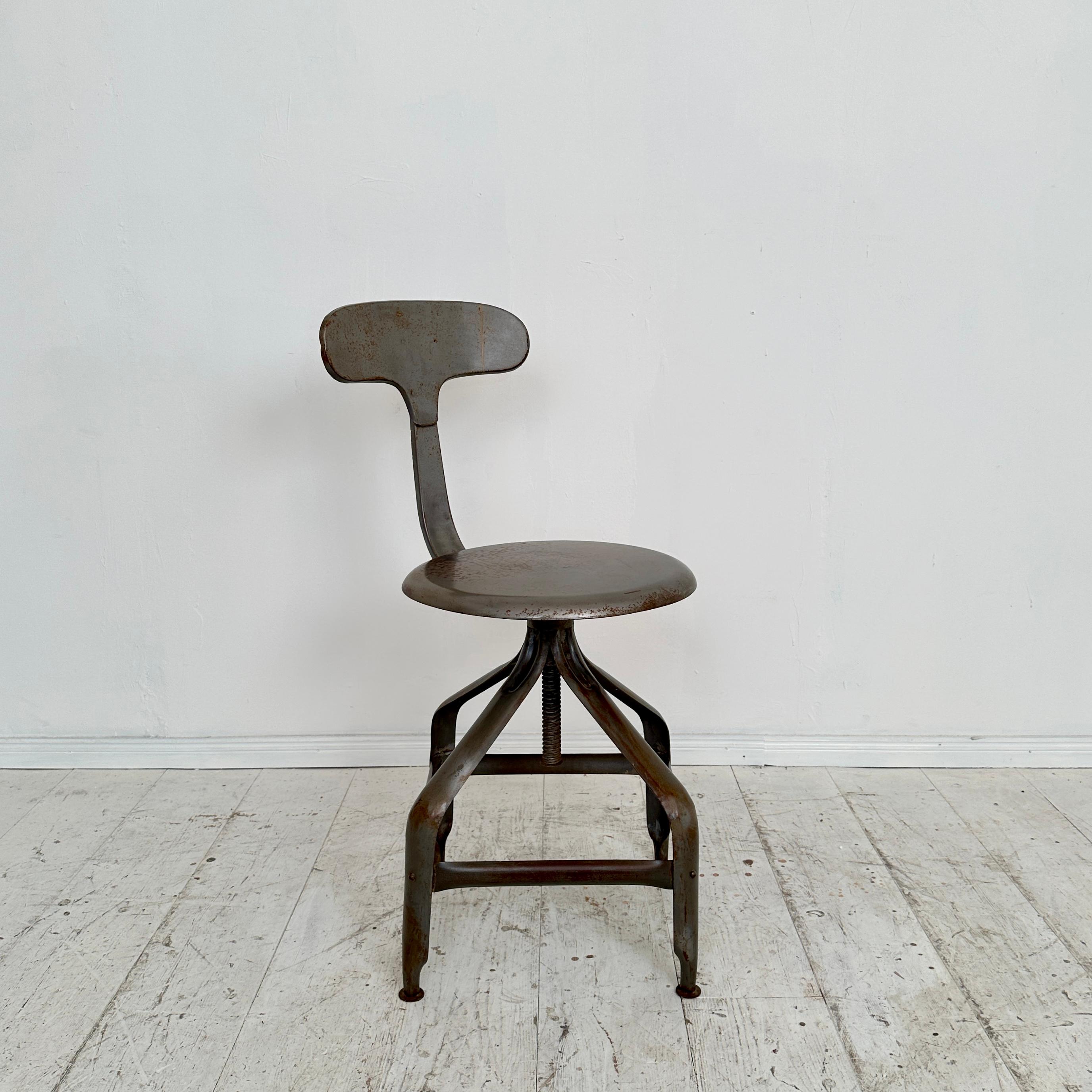 Step back in time to the rugged charm of the 1950s with this exceptional industrial swivel chair, a true one-of-a-kind piece. Crafted entirely from metal, it embodies the durability and utilitarian aesthetic of the era. The sturdy construction