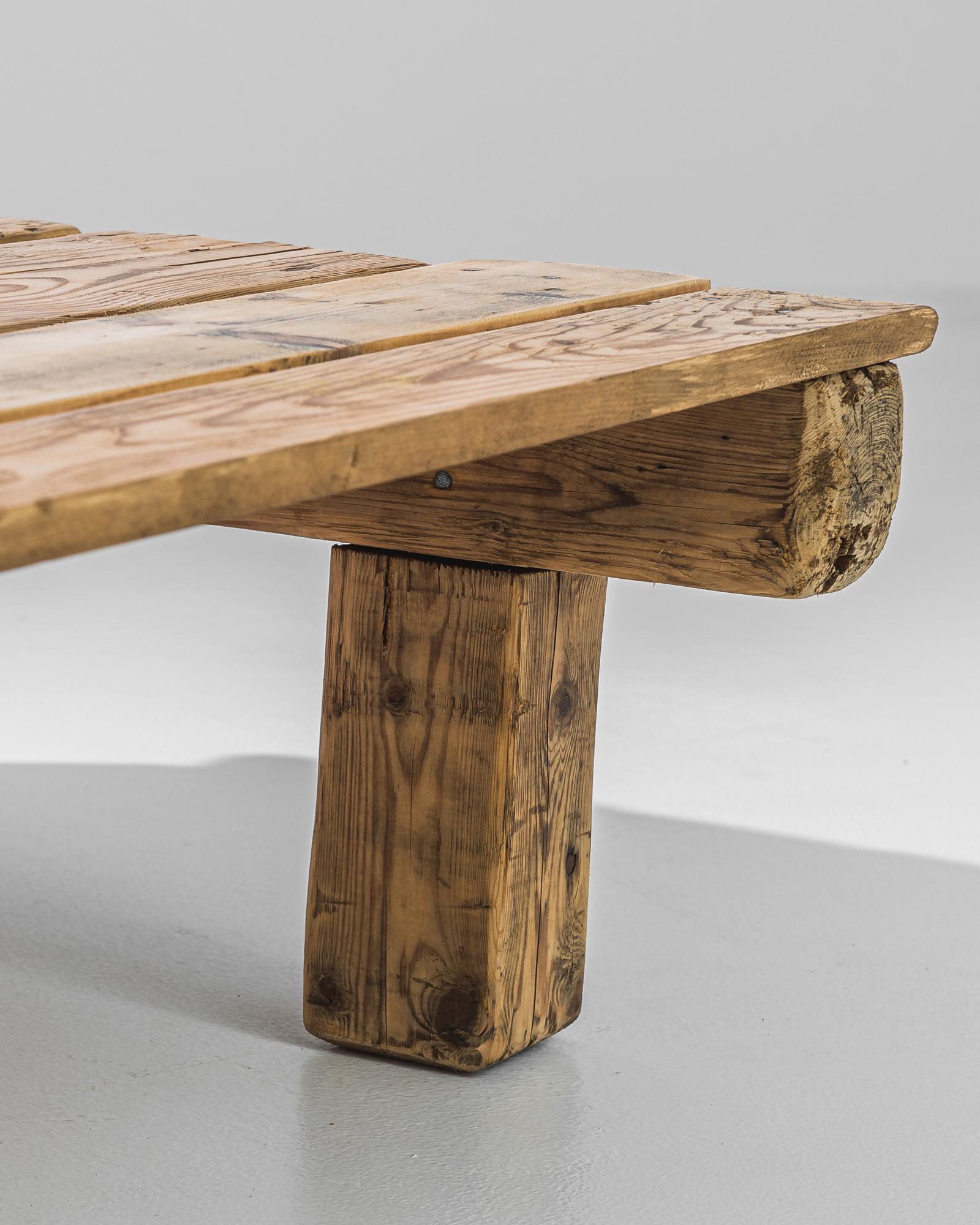 Mellow and rustic, this wooden coffee table has an unvarnished simplicity. Made in Czechia in the 1950s, a low-set tabletop of wooden boards rests upon an arrangement of wooden posts. The organic finish and soft biscuit tone of the natural wood give