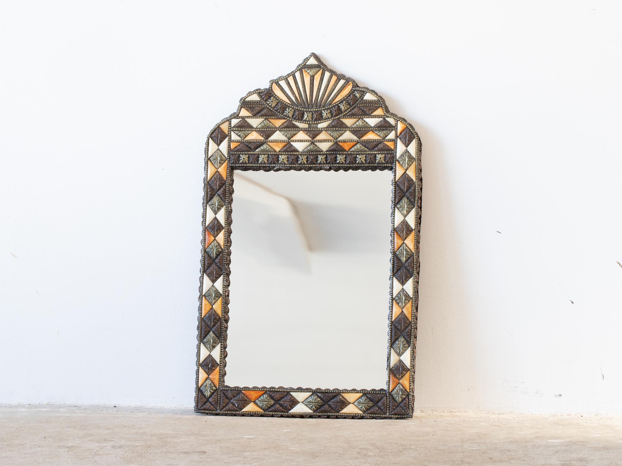 An arched Moroccan mirror with bone, brass and copper inlay, c. 1950s.

In good order with no losses, original glass.

67.5 x 41 cm

26.6 x 16.1 