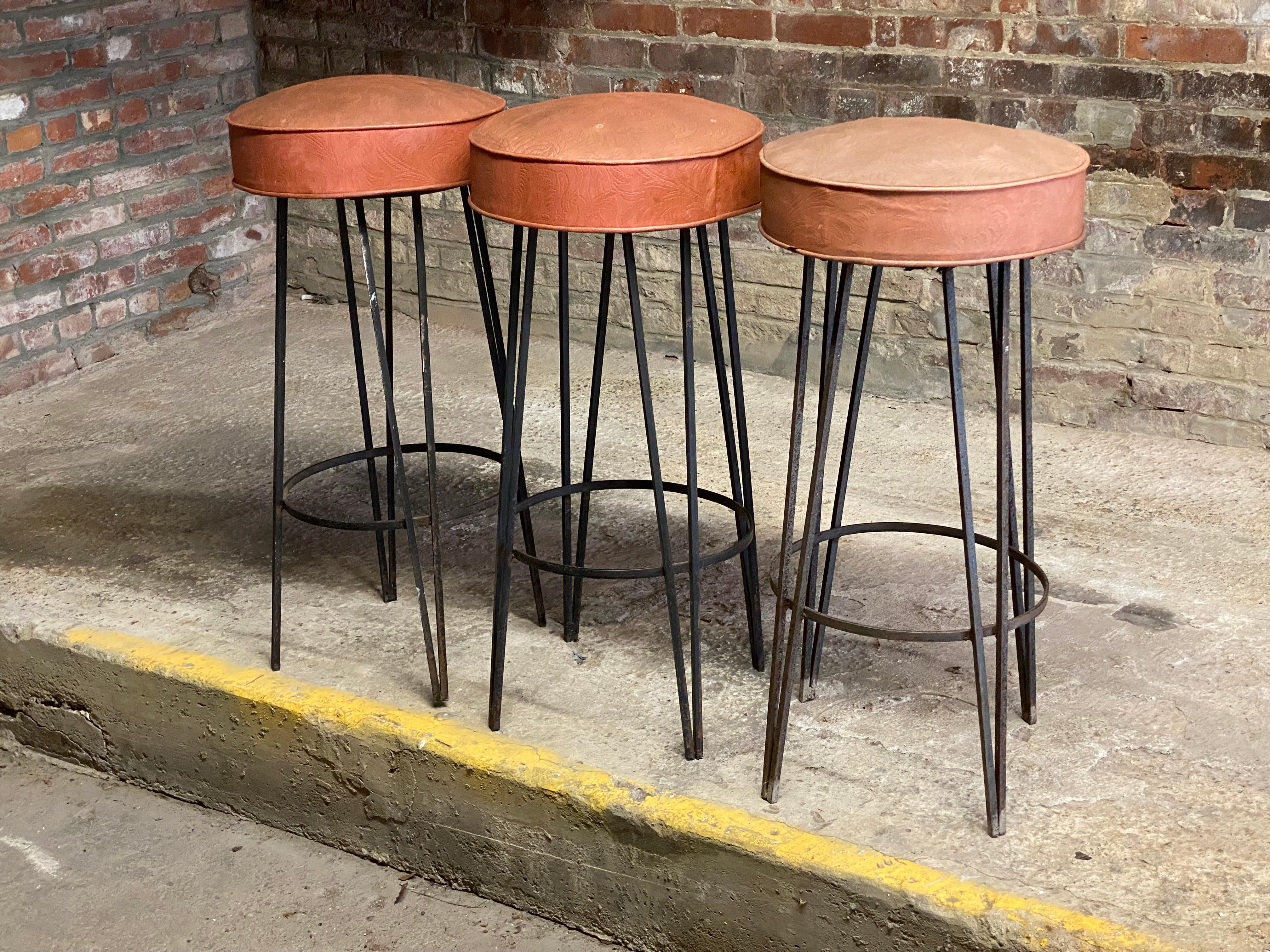 Three stools from World Seating, Inc., Bowery, NYC. Stationary seats that do not swivel. Floral vinyl upholstered seats. 

Good overall condition and structurally sound and sturdy. All welds are visibly intact. Some light rust and minor cosmetic