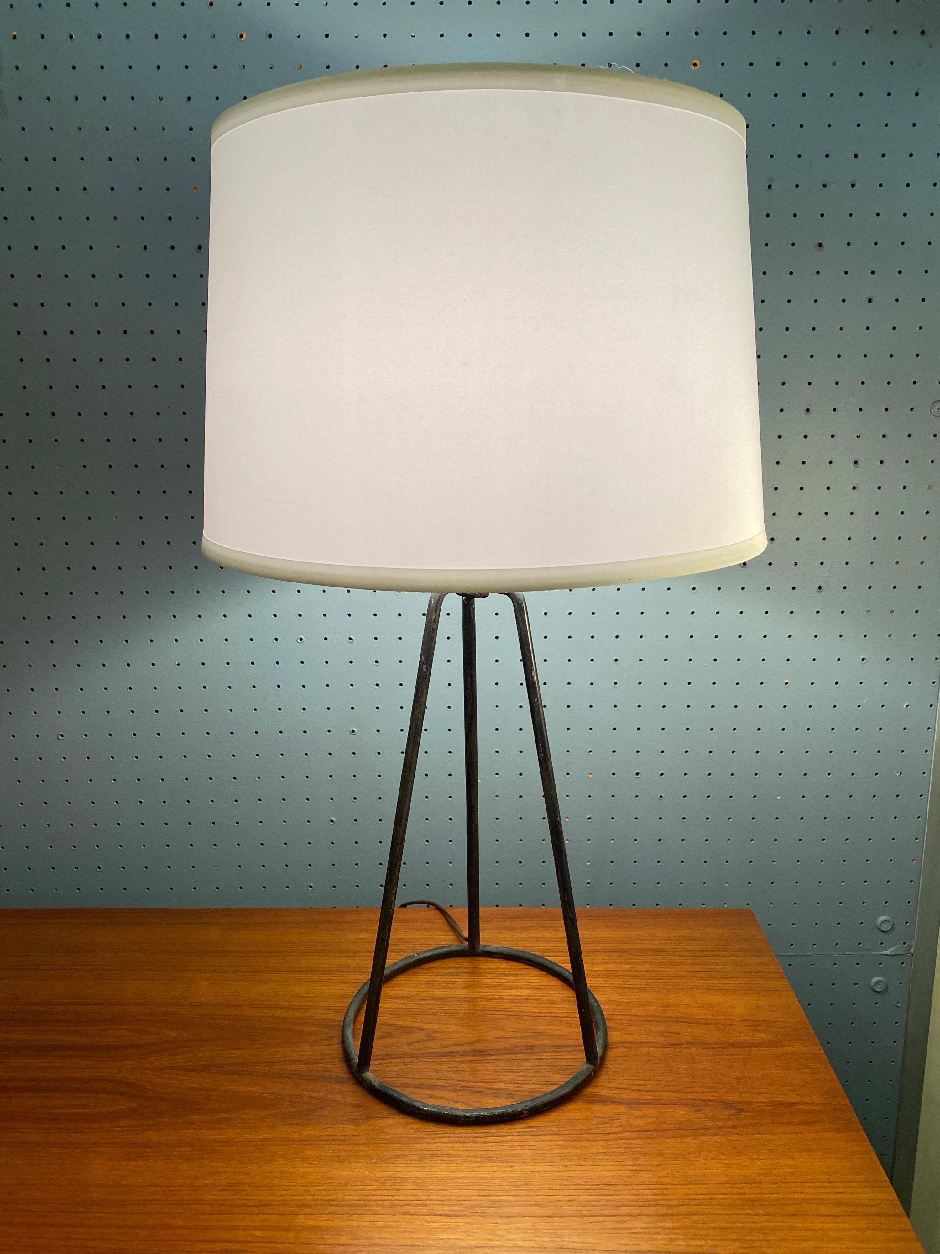 1950s iron tripod lamp with a round tubular base. Classic clean Lines give this lamp a great look! Base is 8.25 across.