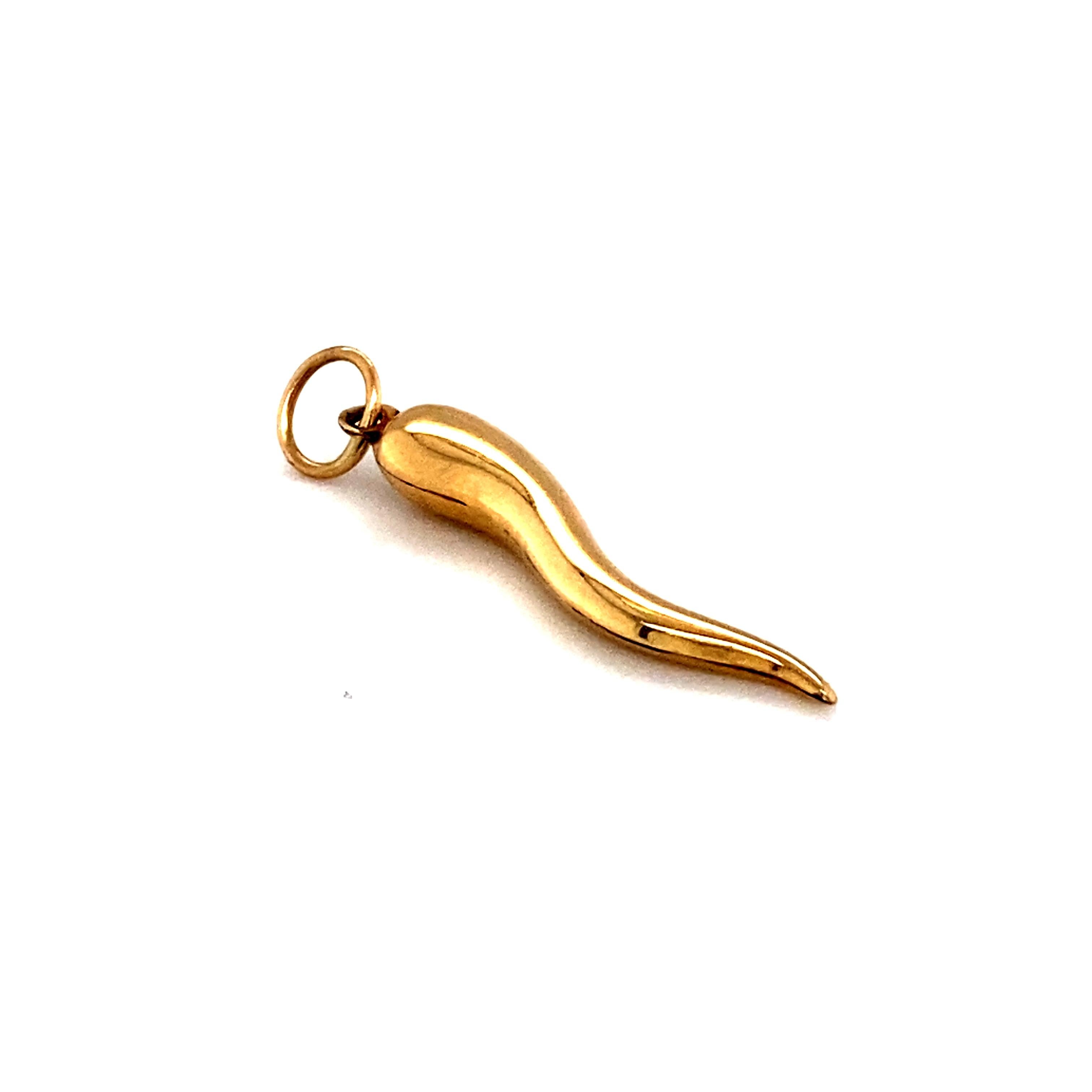 This Cornicello charm, also called an Italian horn, is traditionally worn for good luck and as a talisman. Made of 14 karat gold, this vintage pendant will fit wonderfully amongst your charm collection!

Circa: 1950s
Material: 14 karat yellow gold