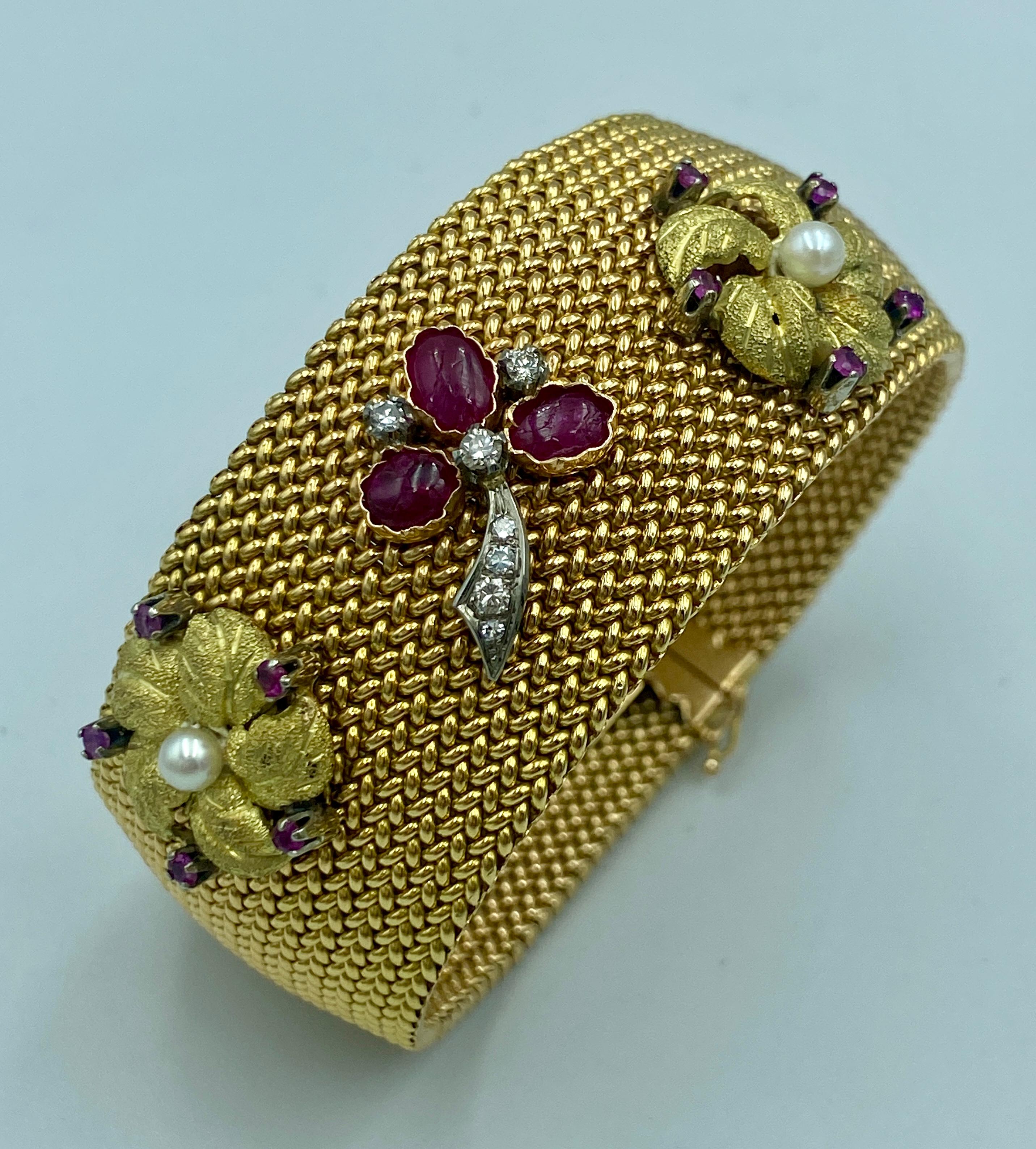 This is a beautiful 1950s Italian cuff bracelet made of hand woven 18k gold. The cuff is adorned with flower and leaf designs made of gold, Burmese rubies, pearls and diamonds. 