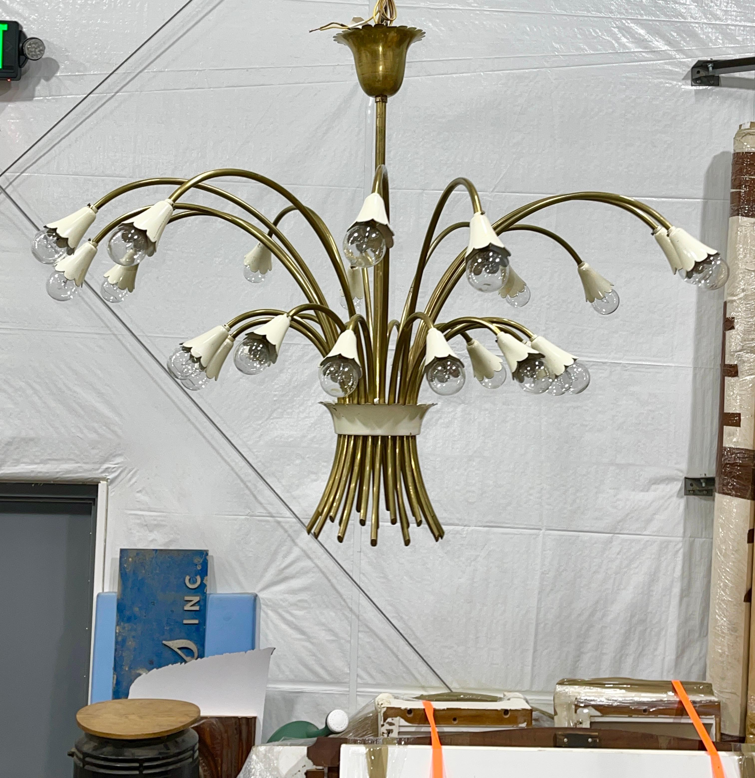 Monumental Italian 1950's botanical bouquet form chandelier with 24 lights at the ends of 24 curved brass tubular arms.
Rewired.
Original brass and porcelain E14 candelabra sockets with adapters for use with American E12 candelabra size