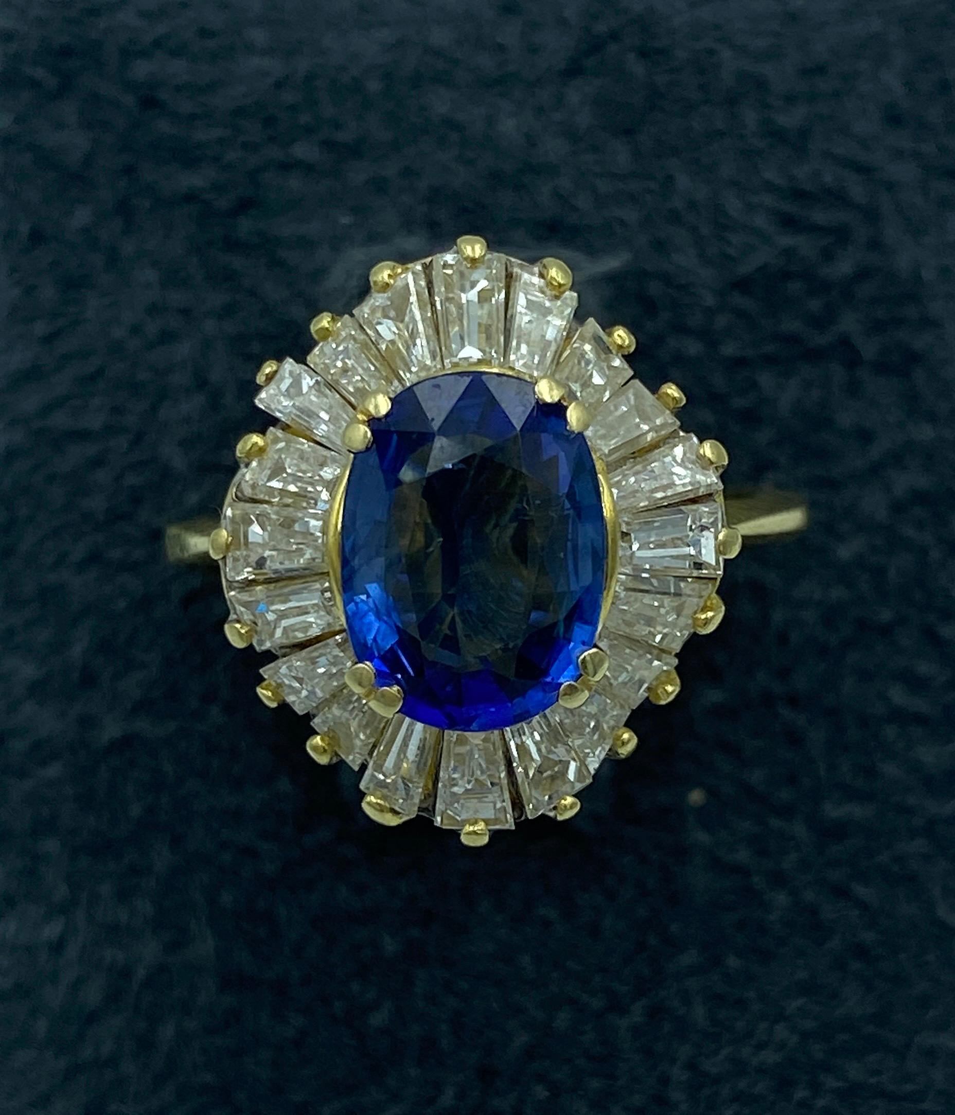 This beautiful 1950s 18 carat gold Italian ring has a Ceylon Sapphire centre stone of approximately 2.5 carats. The sapphire is set among a ring of tapered baguette diamonds creating and undulating effect. The tapered baguette diamonds, which total