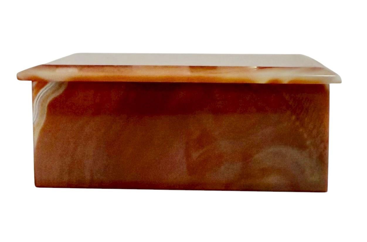 A 1950s Italian agate box, showcasing the natural beauty and translucence of finely polished agate stone. This elegant mid century piece features soft, organic banding in warm earth tones, creating a soothing and luxurious aesthetic. Its smooth