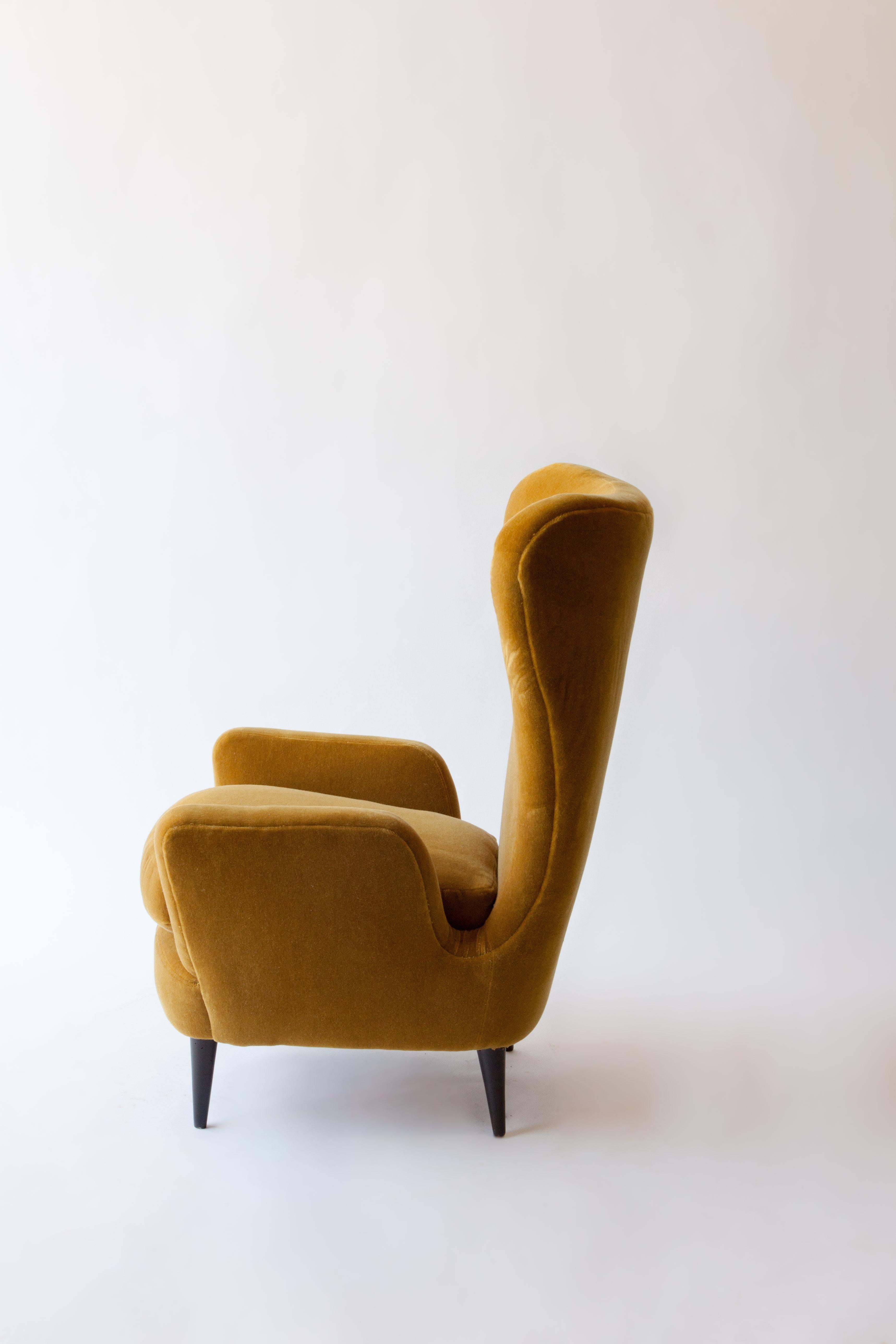 A 1950s Italian armchair attributed to Paolo Buffa newly reupholstered in an ocre wool mohair.