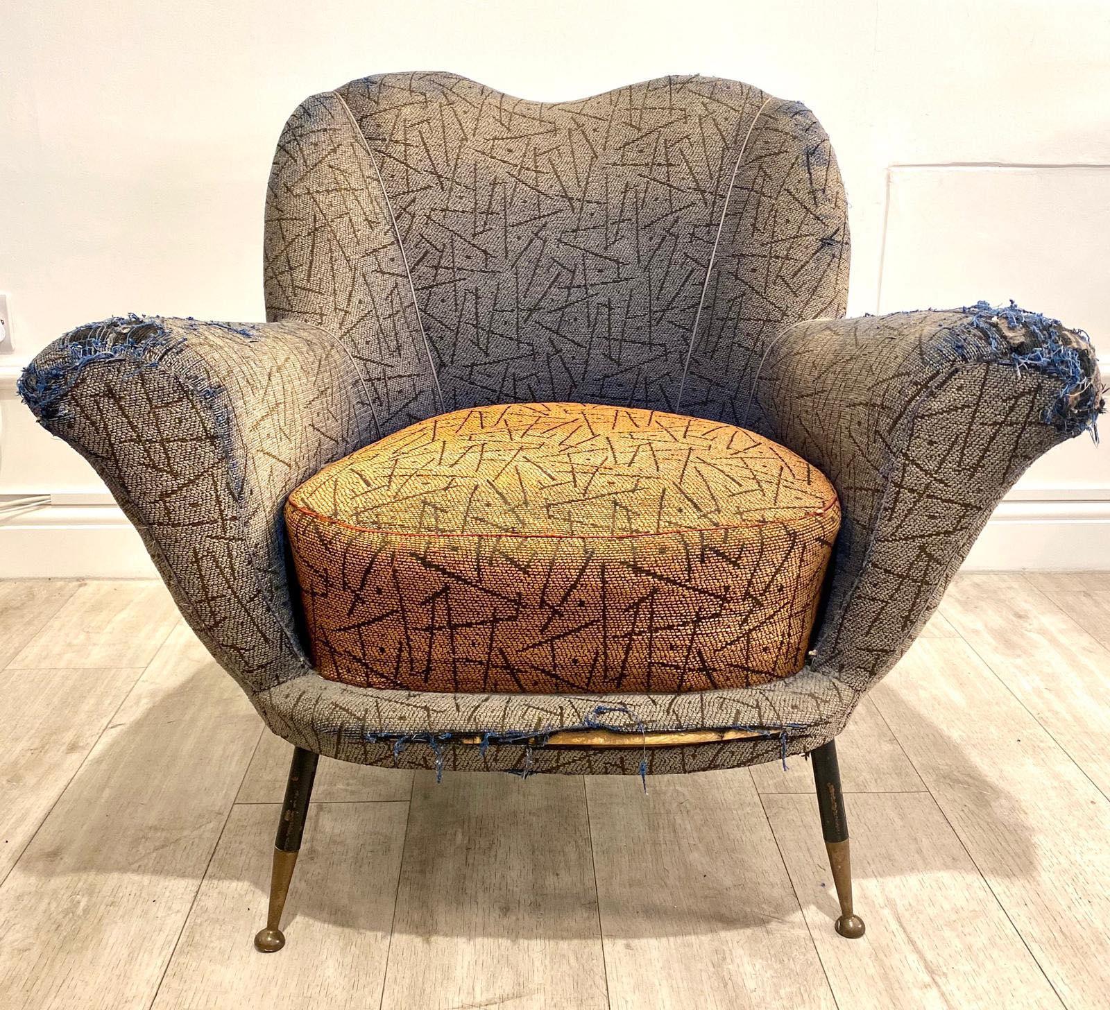 Very cool original 1950s Italian armchair by Poltrona Frau in its original upholstery set on elegant tall and thin black steel legs with brass feet caps. 

Really nice and unusual shape with lovely proportions. 

Would be perfect for