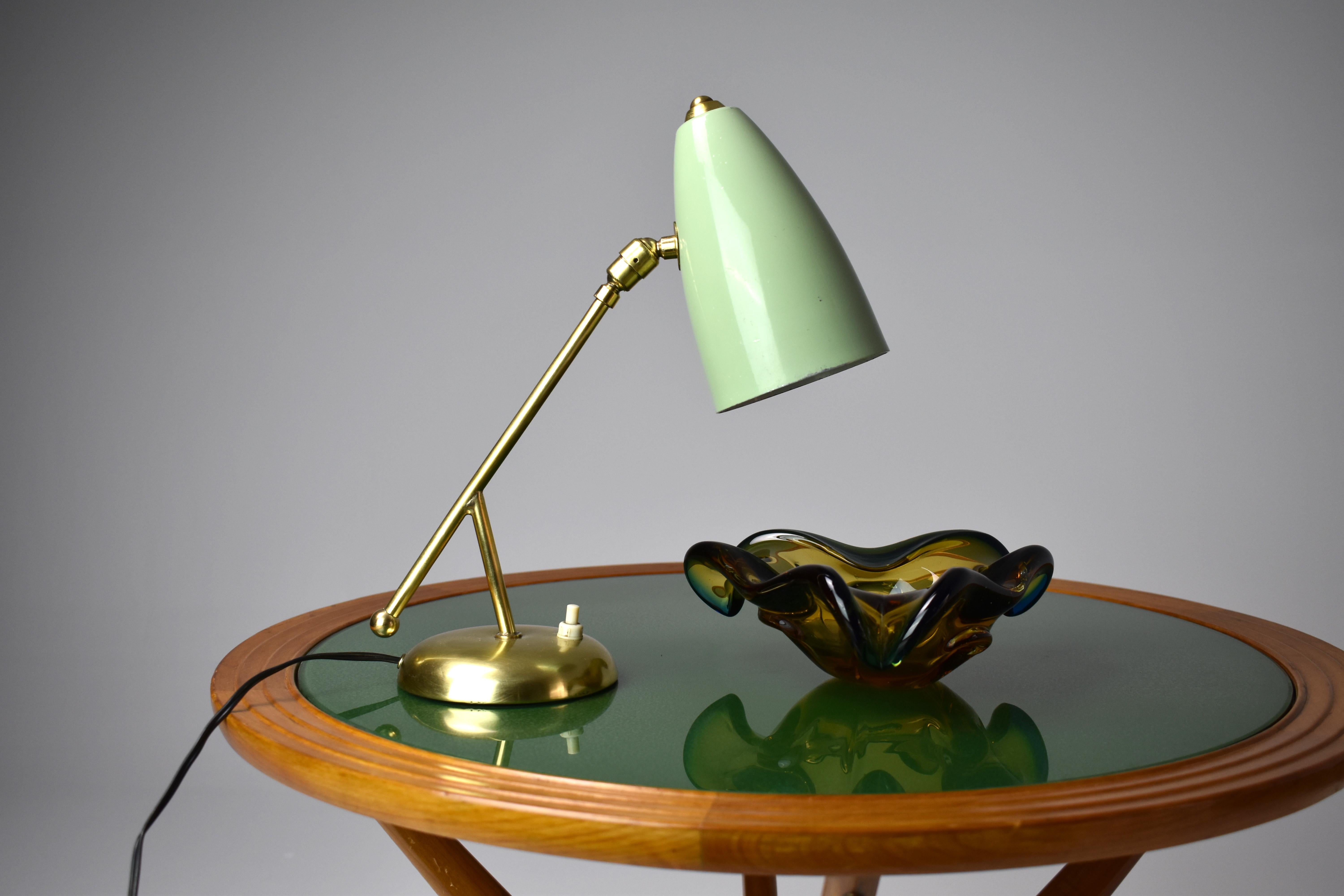 A beautiful Italian Mid-Century Modern vintage desk lamp with cone shade and double articulating solid polished brass structure. 
In rare original mint green color. 
Italy. Circa 1950's 
Professionally re-wired and tested Fits Bulbs E26 /
