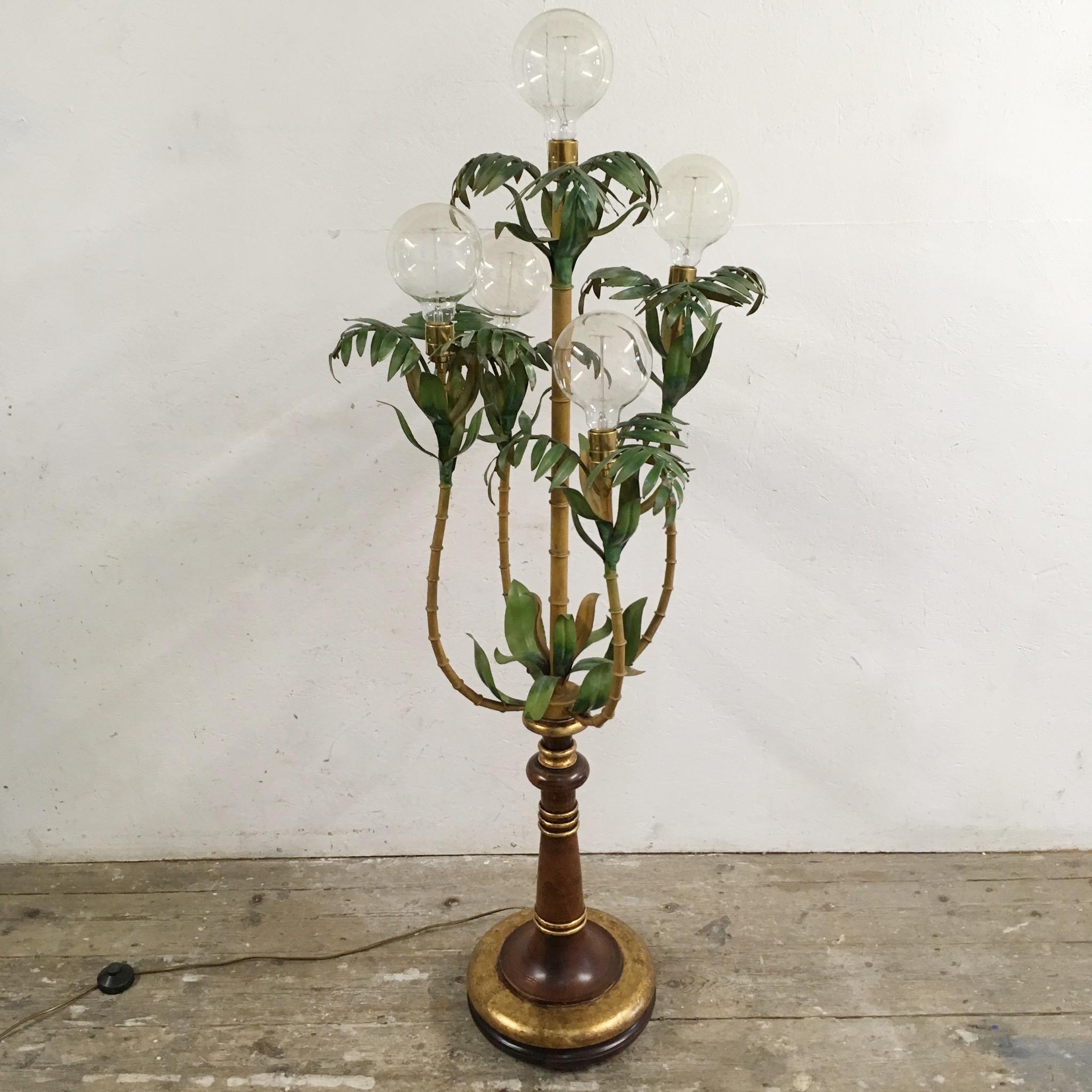Rare and beautiful Italian 1950s tole floor lamp

This lamp is stunning and a large statement piece

The base is beautifully carved solid wood with gilt detail

The top of the lamp is the metal bamboo stems and palm leaf design

The lamp has five