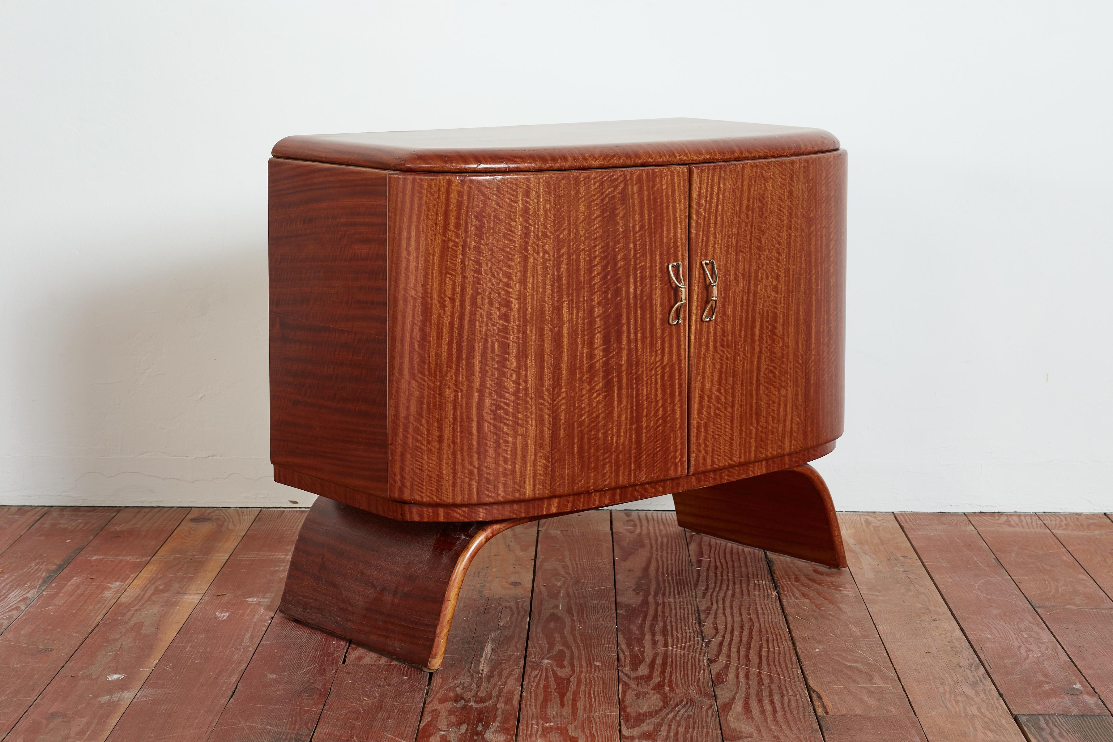 Gorgeous 1950's Italian Bar Cabinet by Galleria Mobli D'arte Cantu 
Petite in scale with curved shape and sculptural bent walnut base 
Cabinet doors open to mirror with ornate brass hardware and glass holder. 
Curved interior wood shelves
Wonderful