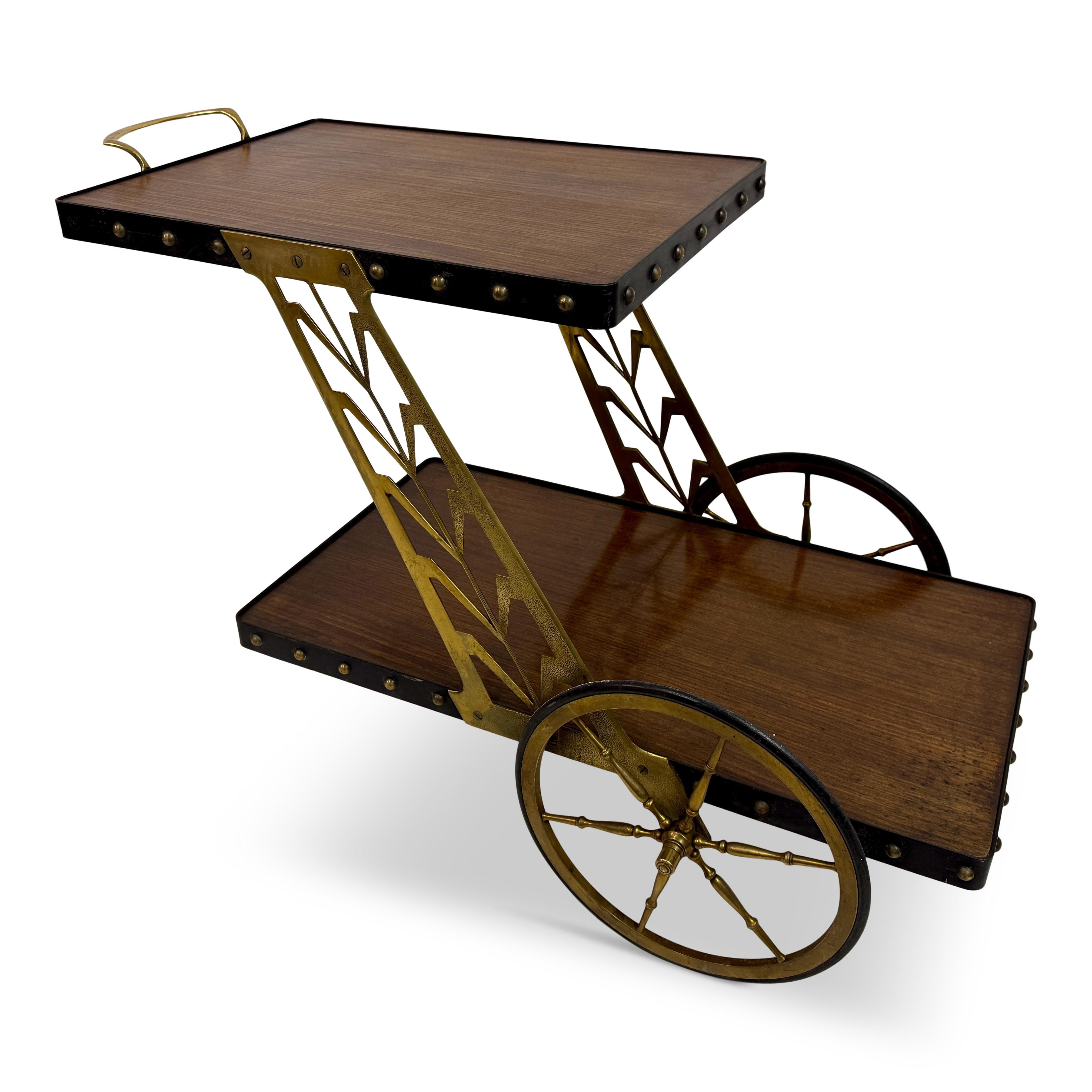 1950s Italian Bar Cart with Sculptural Detailing

A striking mid-century bar cart, likely Italian, dating from the 1950s. The design is bold and architectural — a crisp Z-shaped silhouette joins two wooden trays, each framed in black with brass