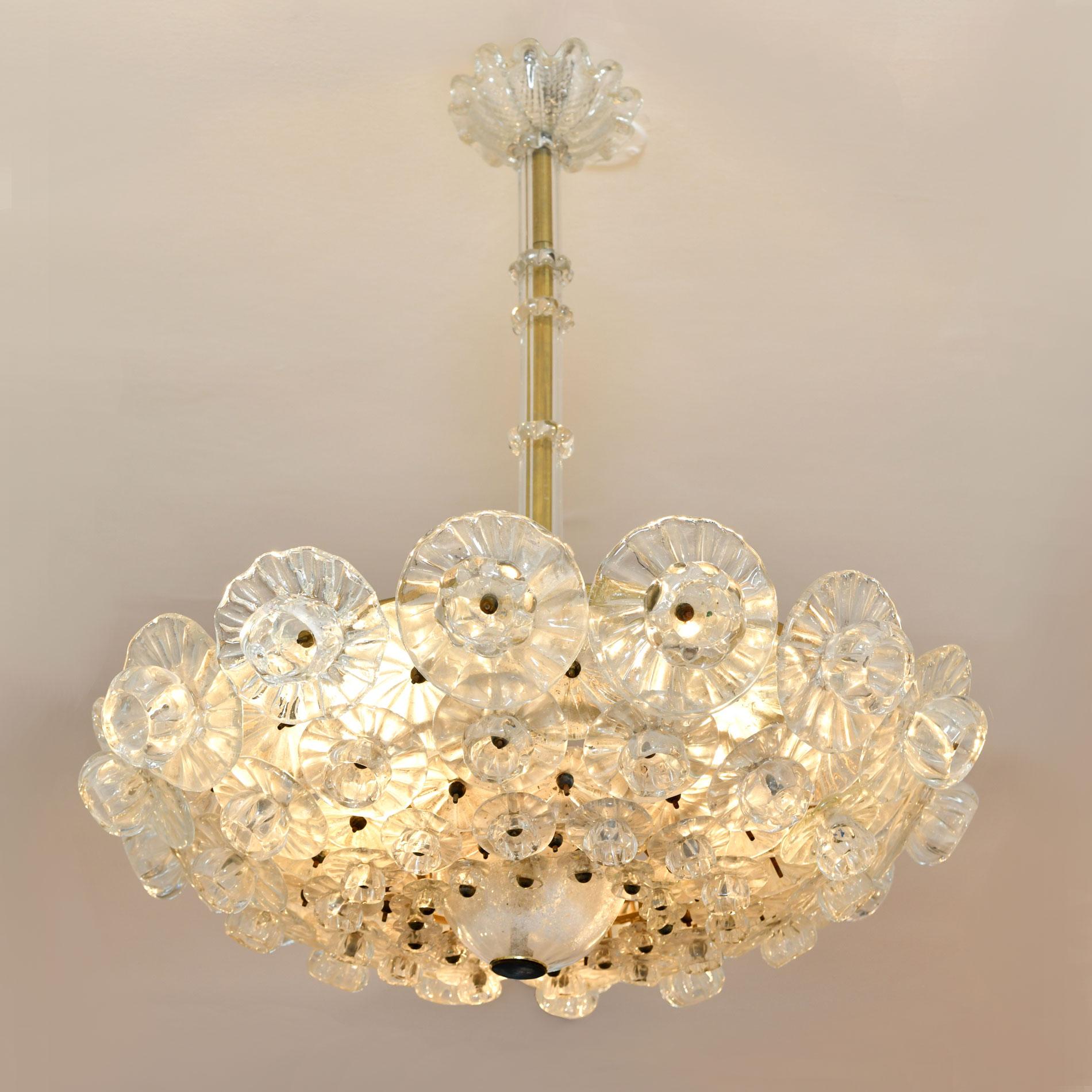 Romantic flower chandelier made up of individual overlapping glass flowers graded in four different sizes. The delicate detailing extends to the glass rod and fluted ceiling rose.