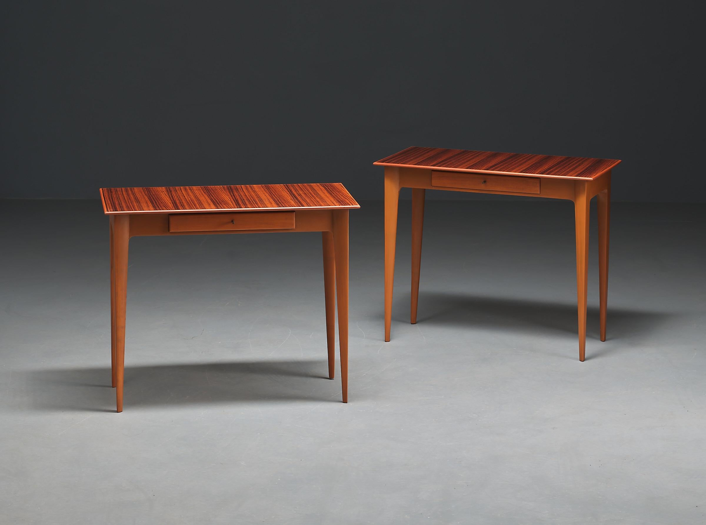 Pair of 1950s Italian side tables that perfectly encapsulate the Italian design aesthetic of the era. Crafted from fine wood with slender tapered legs, these tables are a testament to Italian craftsmanship at its finest.

The teak veneer tabletop
