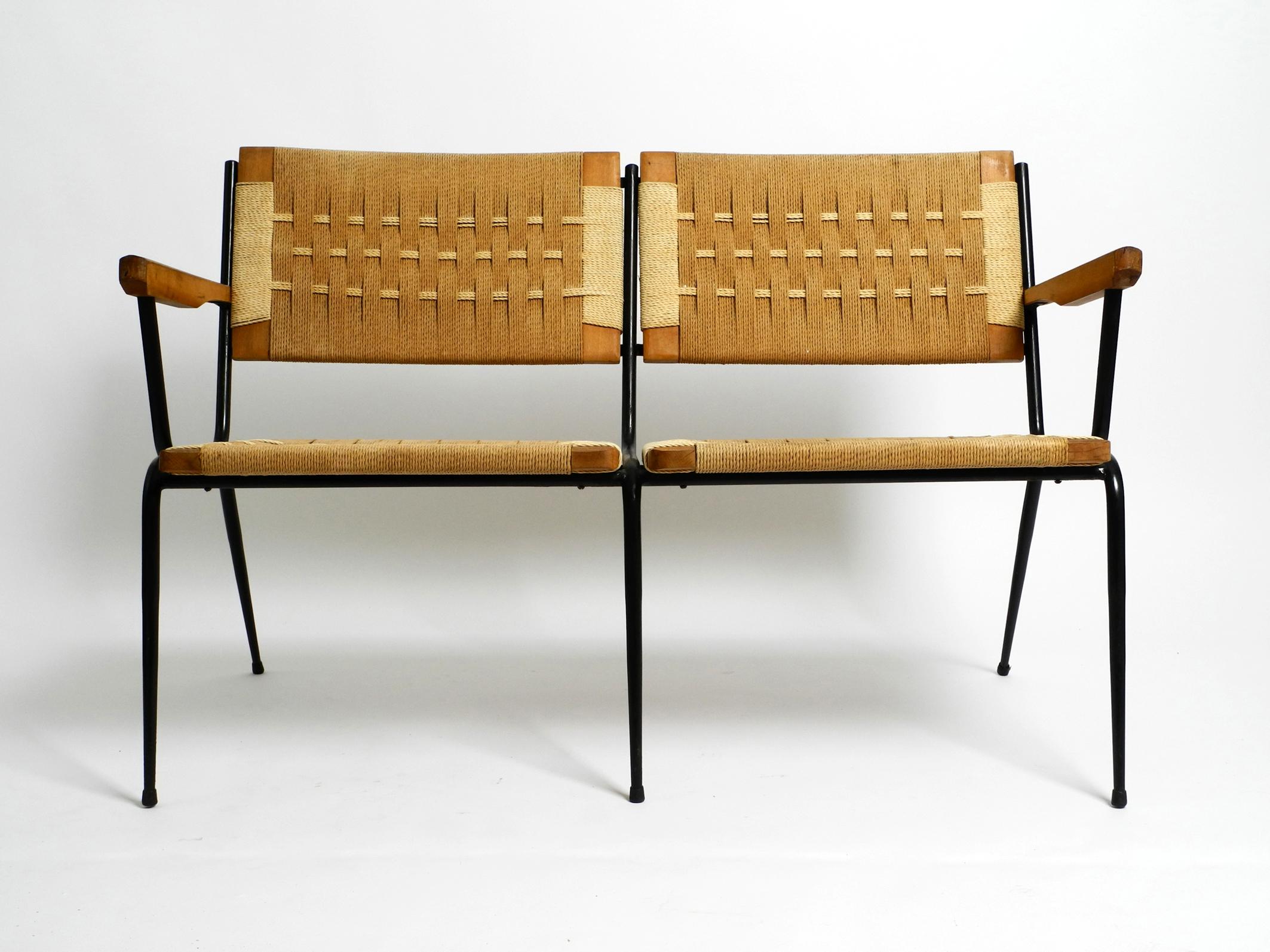 Beautiful Mid Century Italian 2-seater bench made of iron.
The frames for the seats and backrests are made of wood with wickerwork.
Great 1950's Italian design. Design by Giuseppe Pagano Pogatschnig, an Italian architect and designer.
The seats and