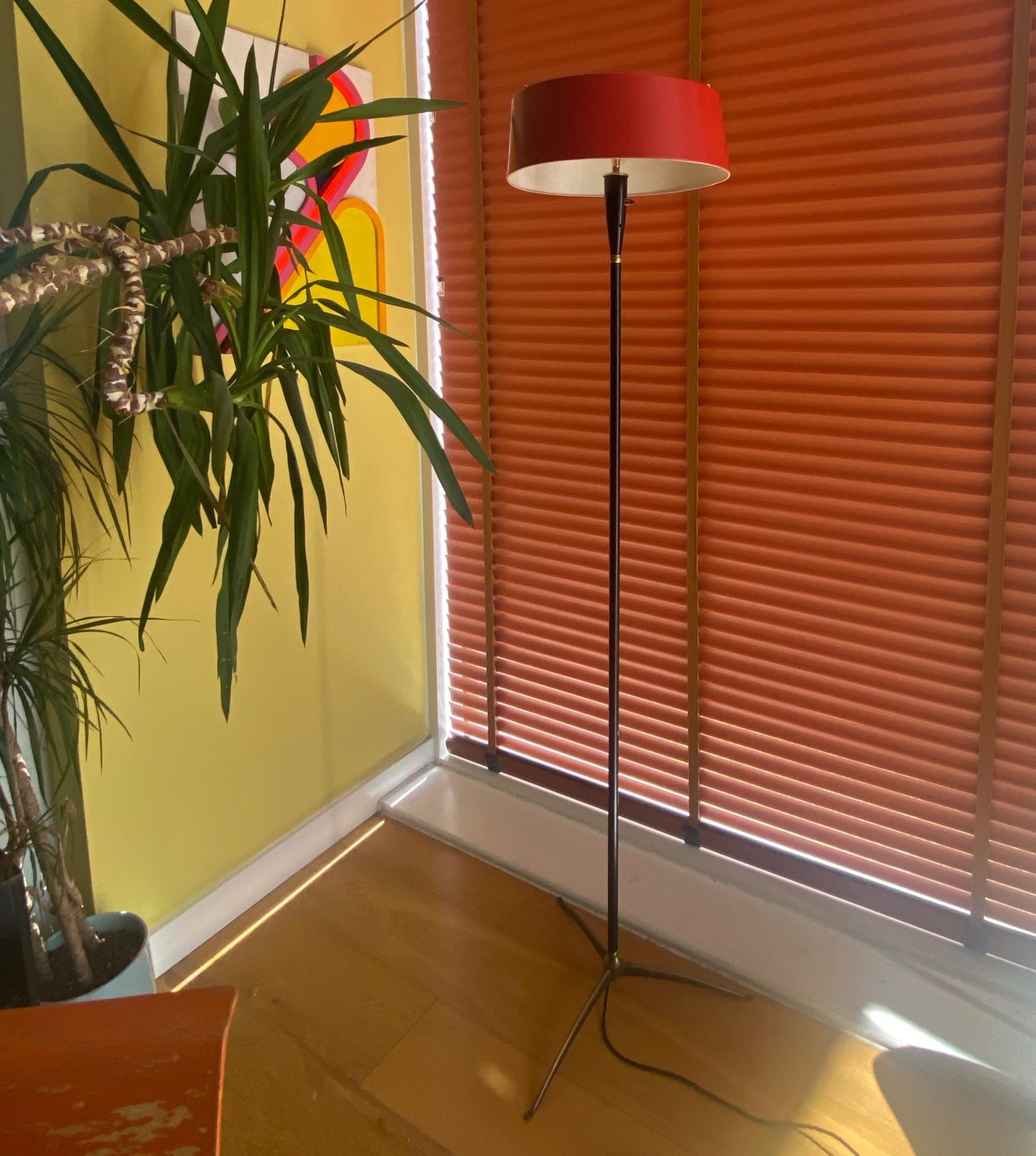 This is an unusual, stylish Italian floor lamp from the 1950's. It is very similar to the designs of Oscar Torlasco for Lumi. The red shade can be tilted in all directions which is quite fun and practical. The brass lightbulb holders are really