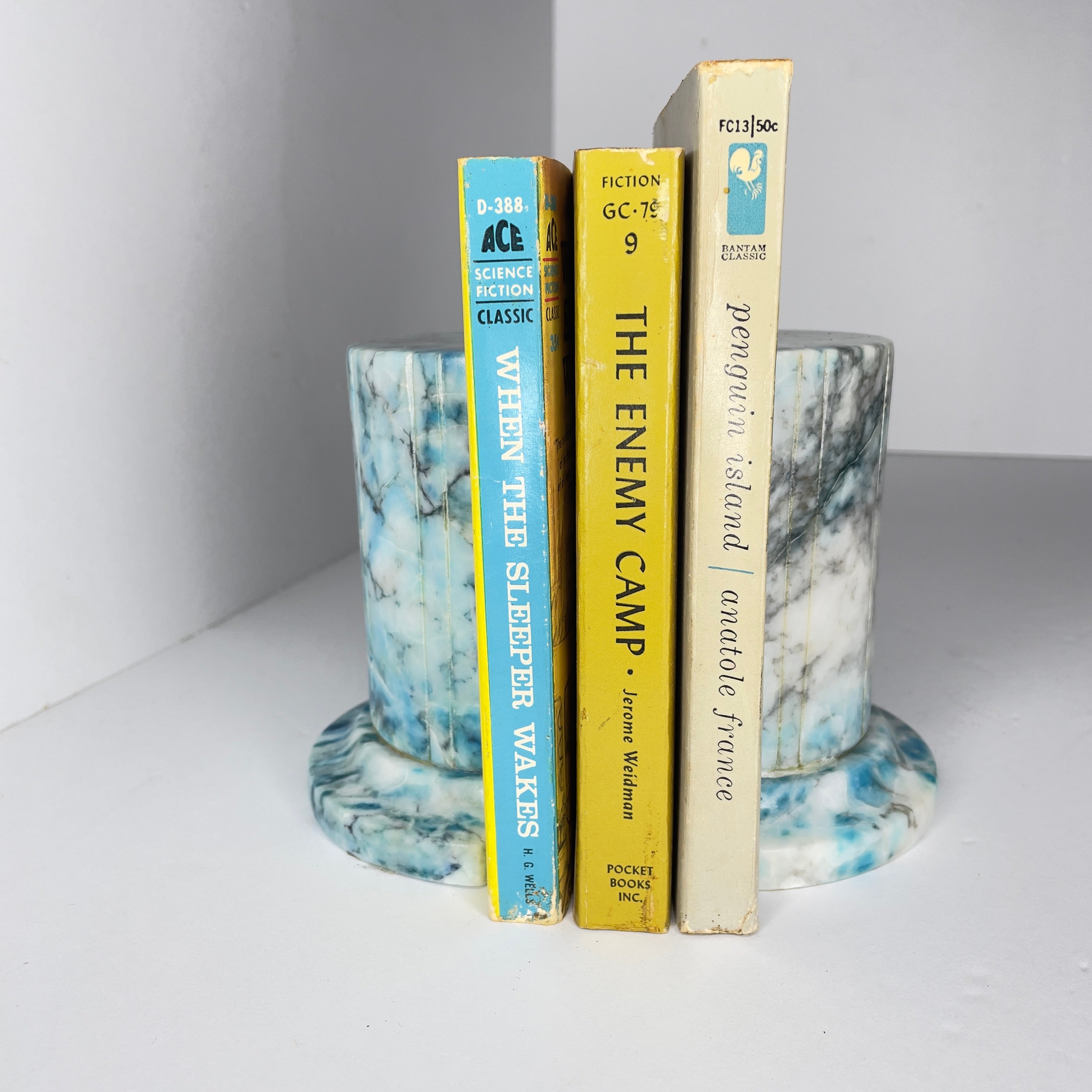 Pair of vintage blue alabaster marble bookends which have recently been refinished and polished to a high gloss finish. The original finish was yellowing and failing substantially. Now, these bookends are good for another 70 years. The original