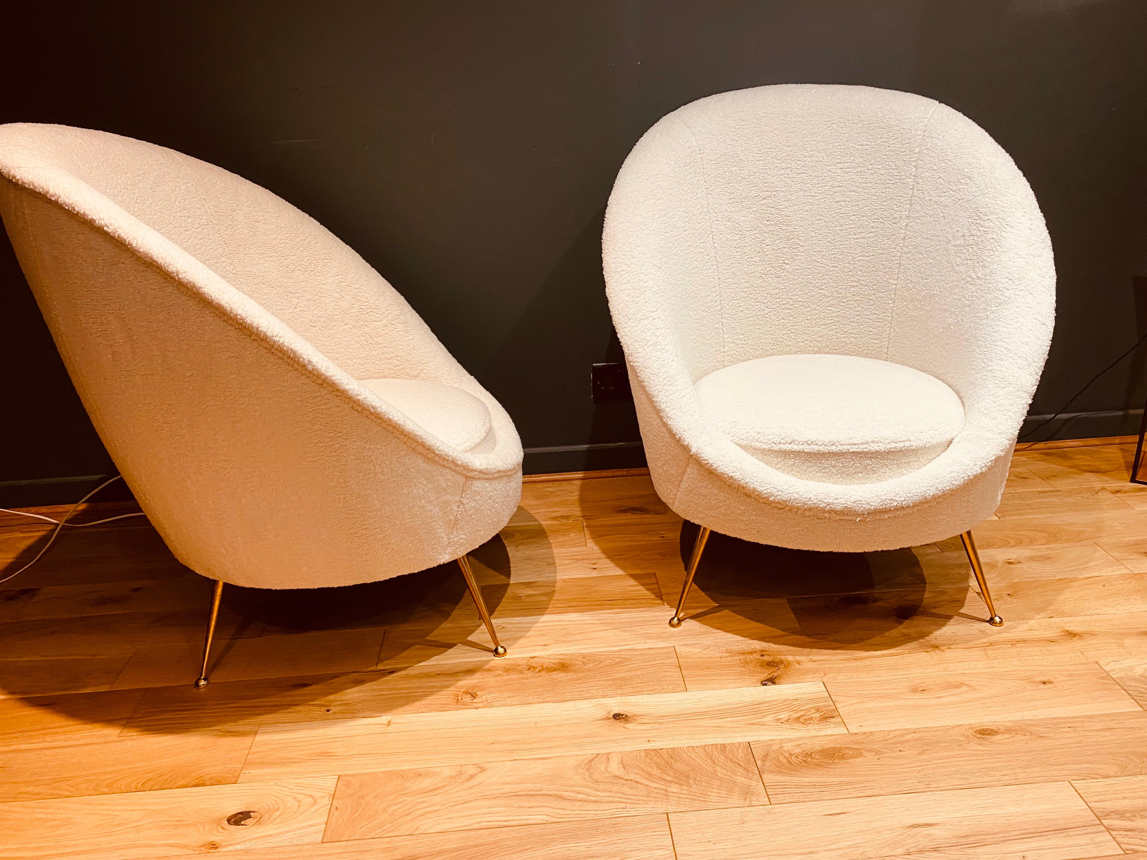 A beautiful pair of Italian lambswool boucle cocktail chairs standing on brass feet. These have been professionally re-upholstered in Milan and are in exceptional condition.