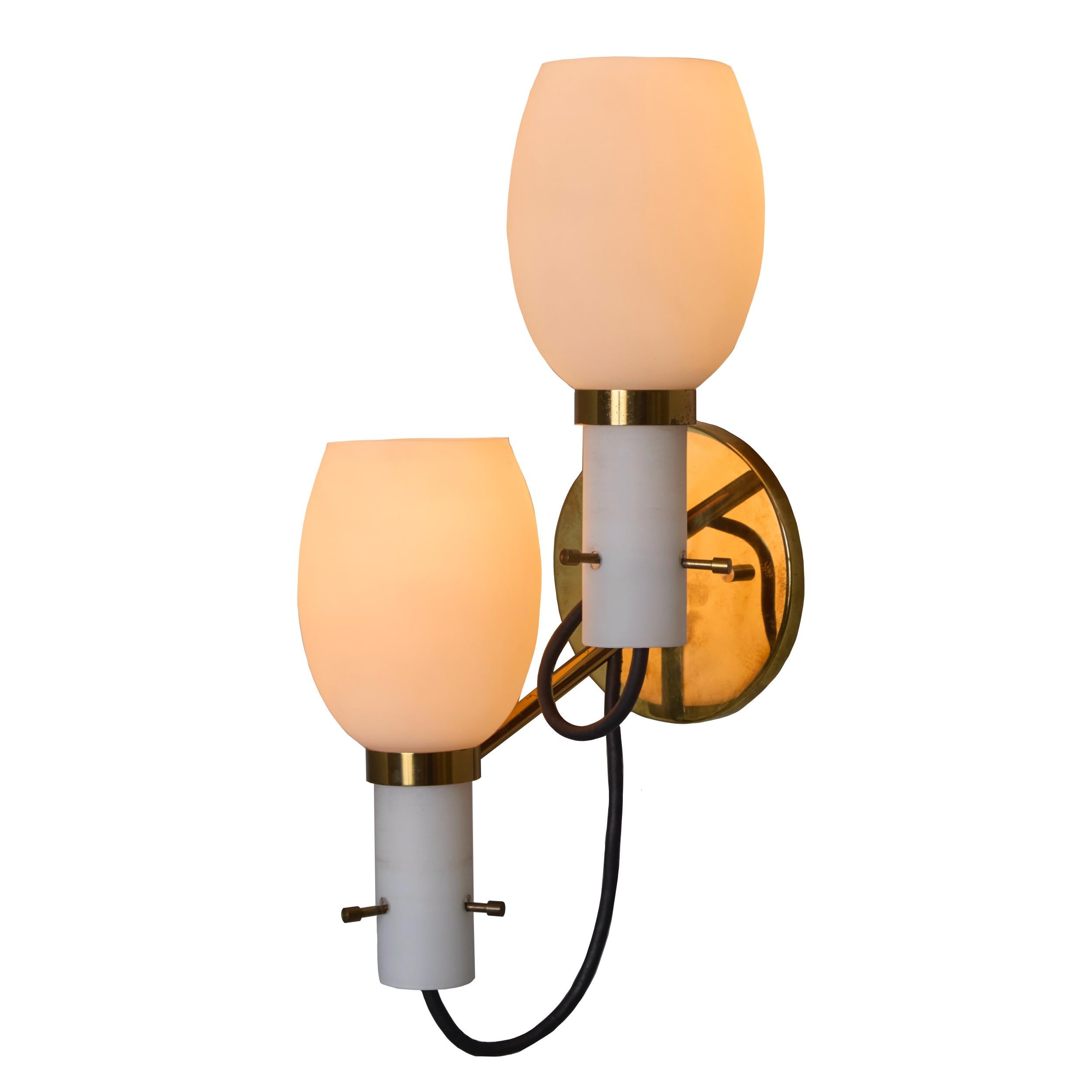 1950s Italian Brass and Opaline Glass Double Sconce in the Manner of Stilnovo. Executed in polished brass hardware with two sculptural opaline glass shades, each providing a warm and diffuse light. An elegant and refined lighting design that