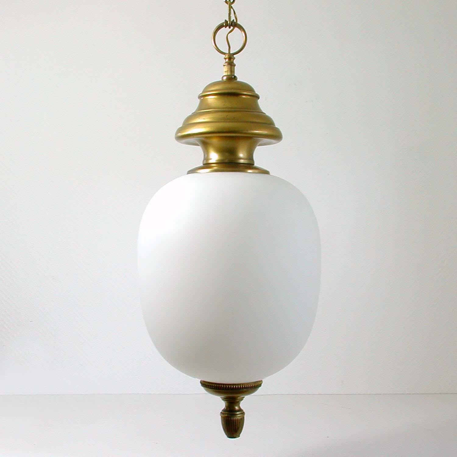 This elegant Italian chandelier / lantern was designed and manufactured by Azucena in the 1950s.

It has got a beautiful white blown satin opaline glass lamp shade, the frame is made of patinated brass.

The electrical system is of the time. The