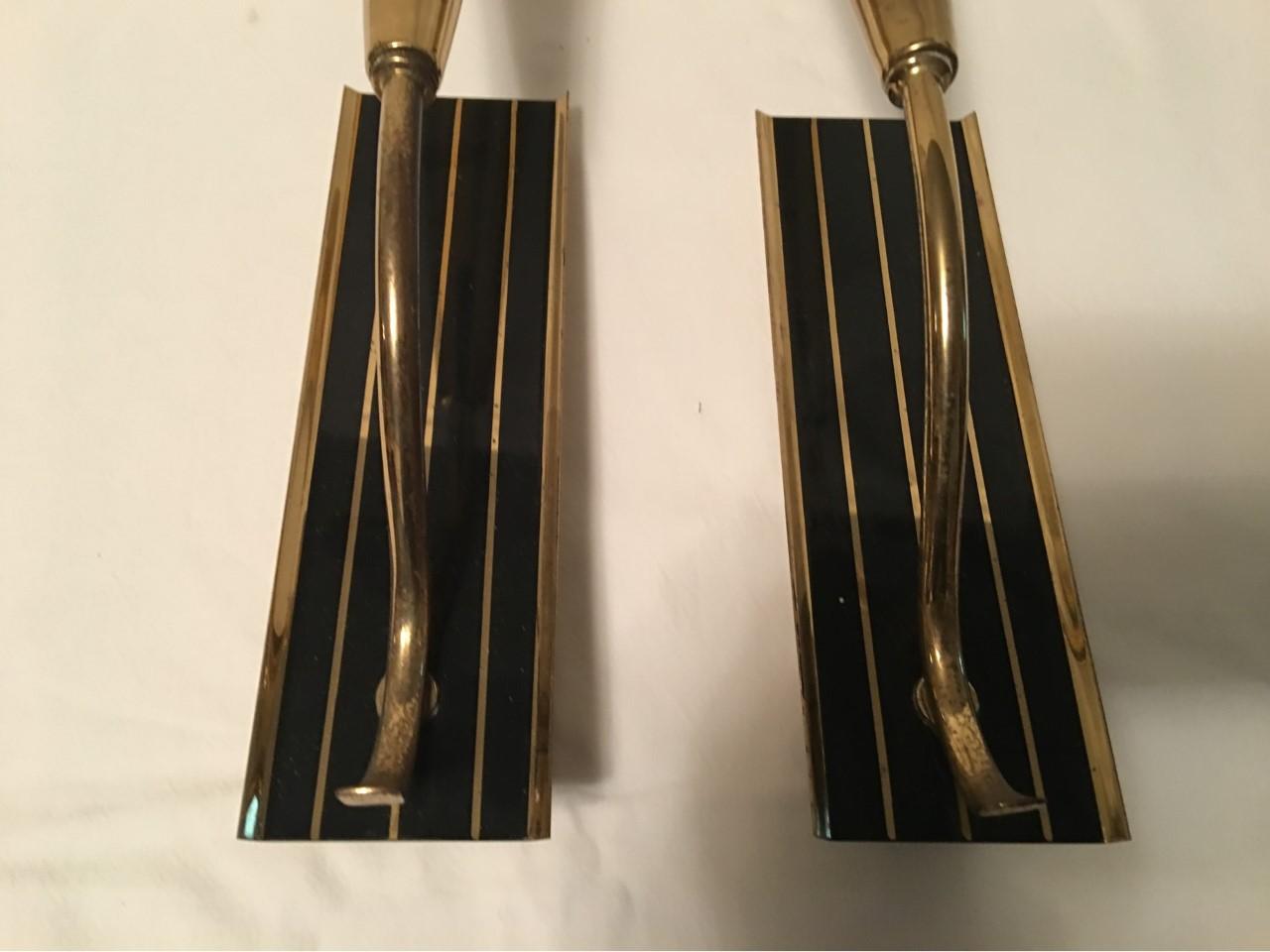 A pair of good looking 1950s Italian brass black striped sconces. The copper and clear styling form are very reminisced of the Classic Art Deco styles. Each fixture requires a European E 14 candelabra bulb up to 60 watts. In good working condition.