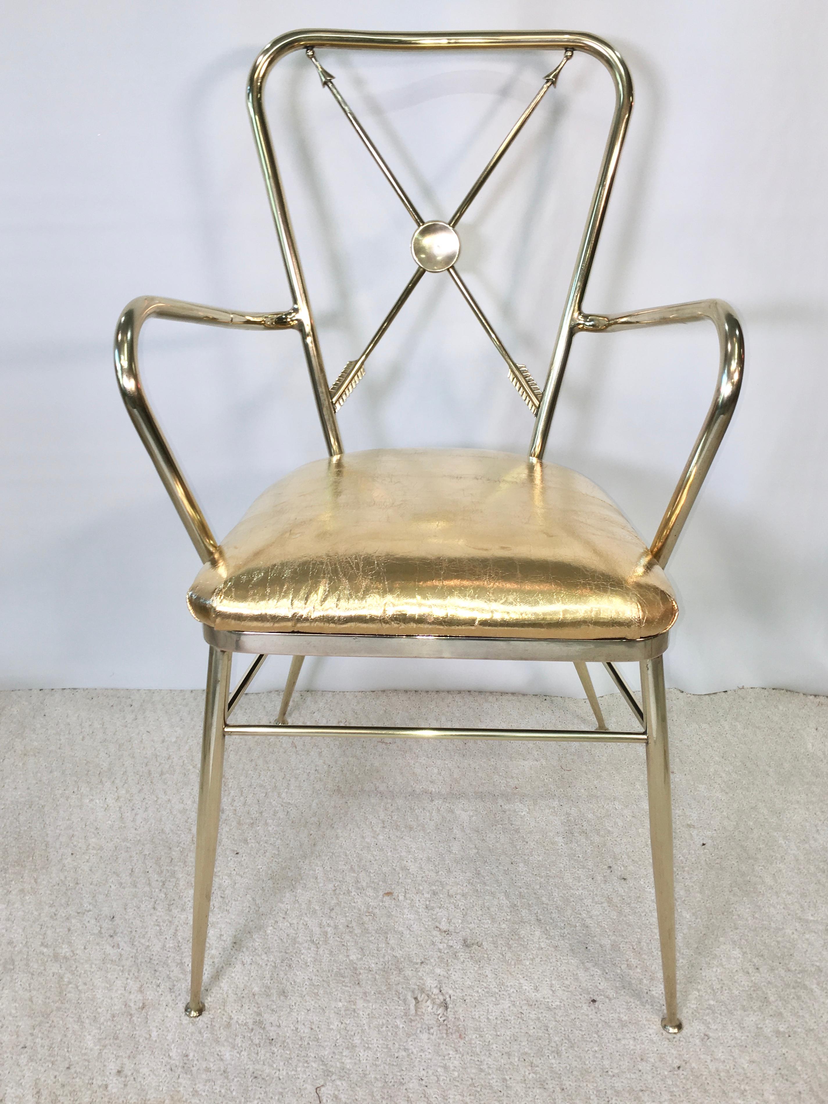 1950s Italian brass Chiavari armchair with crossed arrows motif in the style of Gio Ponti, Tomaso Buzzi and Marc du Plantier.
Seat cushion newly upholstered in vintage gold metallic leather. Hand polished to a mirror finish.
The crossed arrows