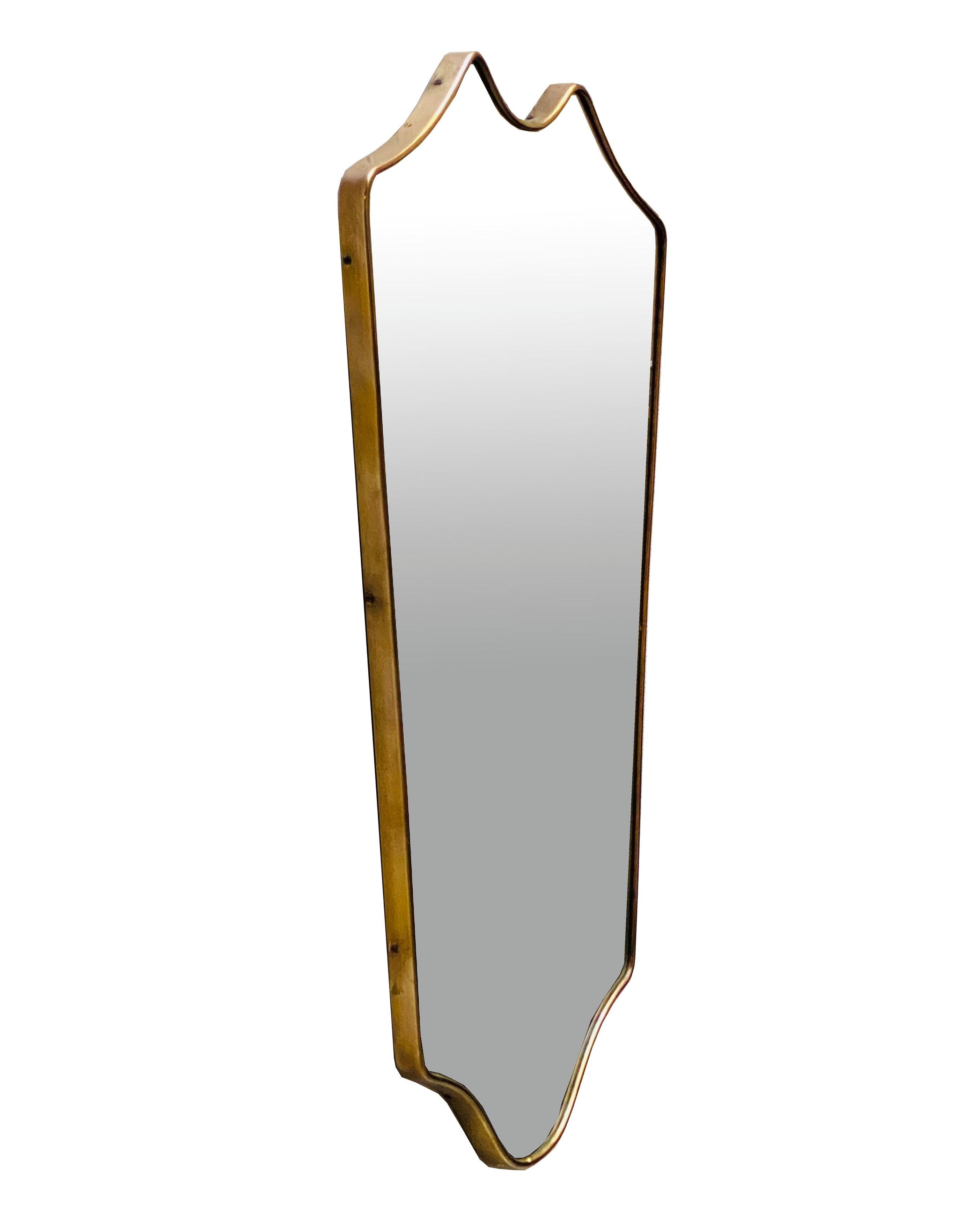 Elegant and solid wall mirror of considerable size, made in Italy, 1950s. The mirror glass is framed in brass. 
Other designers of the period include Gio Ponti, Fontana Arte, Max Ingrand, Franco Albini, and Josef Frank.Mid-century Italian wall