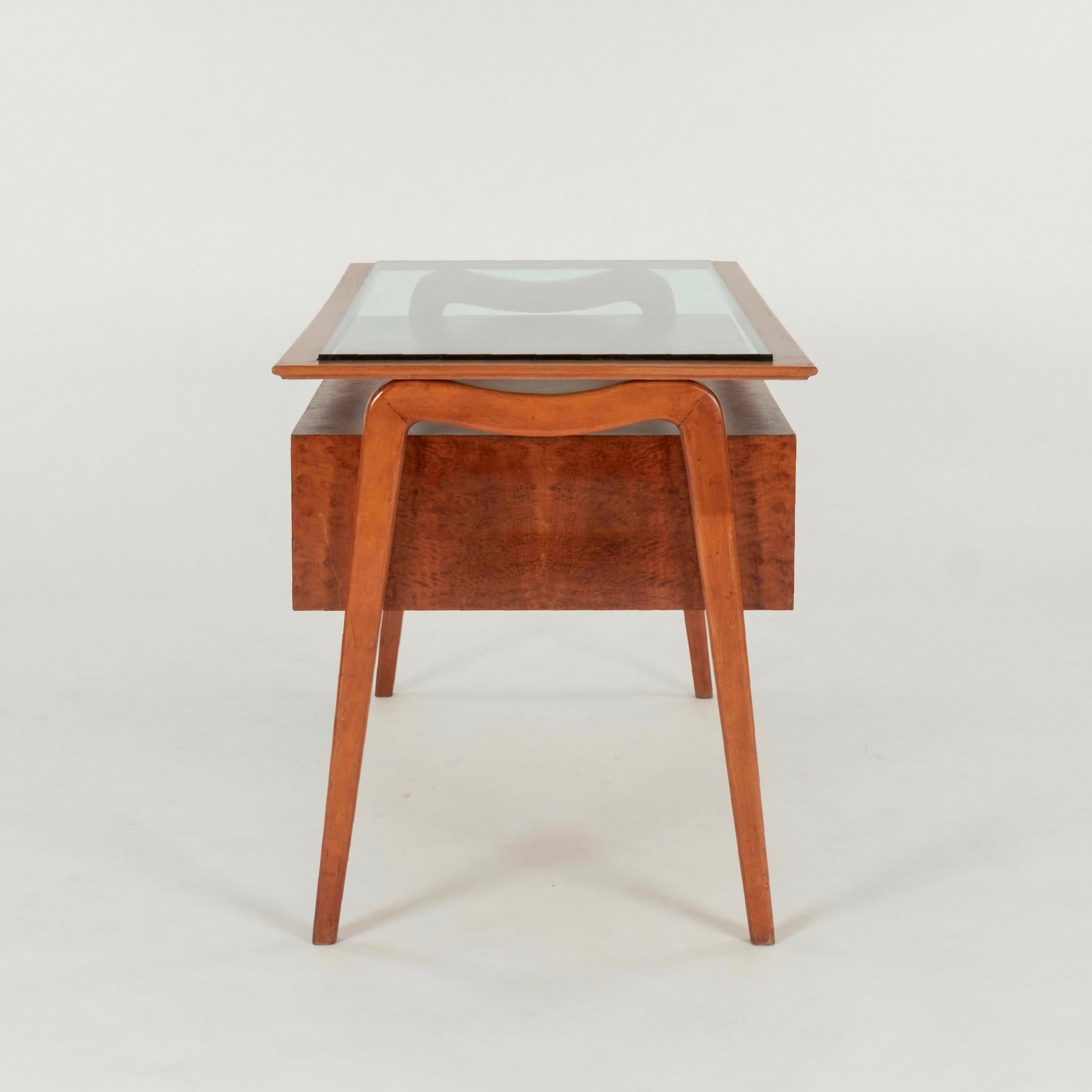 Stylized 1950s Italian burl maple desk with bronze pulls and glass scrivania top.


