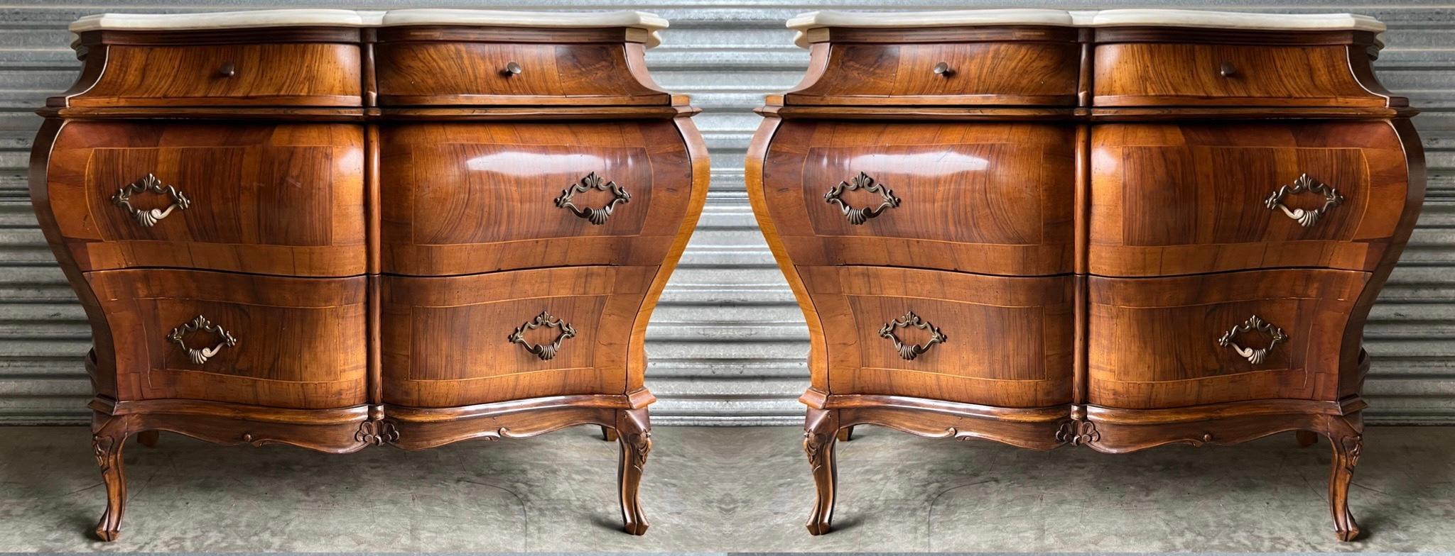 This is a lovely pair of Louis XV style burl walnut inlaid chests hand crafted in Italy for Bethlehem Furniture. The white marble tops are not attached. The brass hardware is original. Note the beautiful serpentine lines across the bombay form!