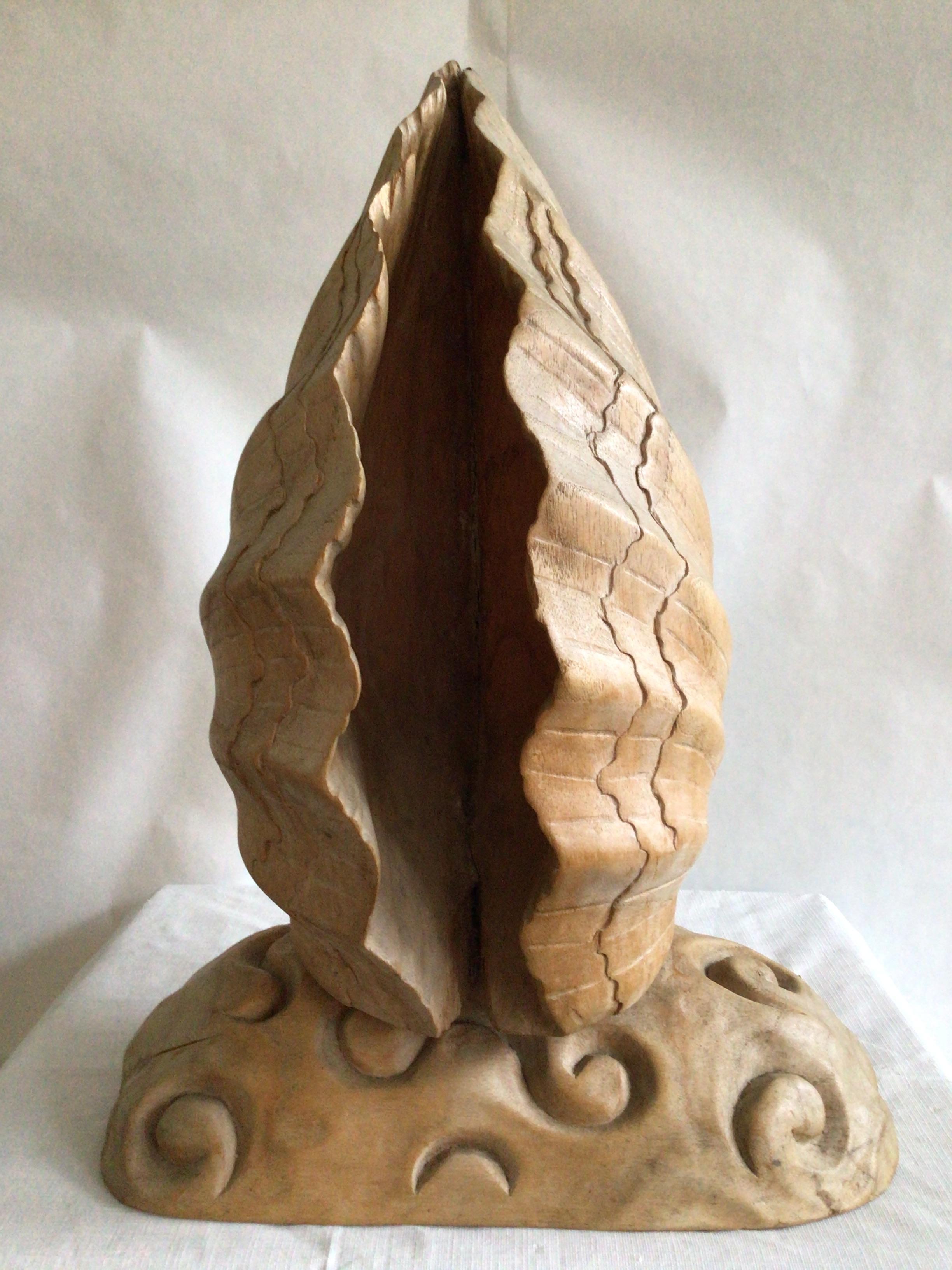 1950s Italian Carved Wood Folded Leaf or Shell Sculpture on Wood Base
Spirals carved in base
Carved Scalloped Edges
Light brown, tan, peaches, and cream colors
Italy carved on underside of base (as pictured)

