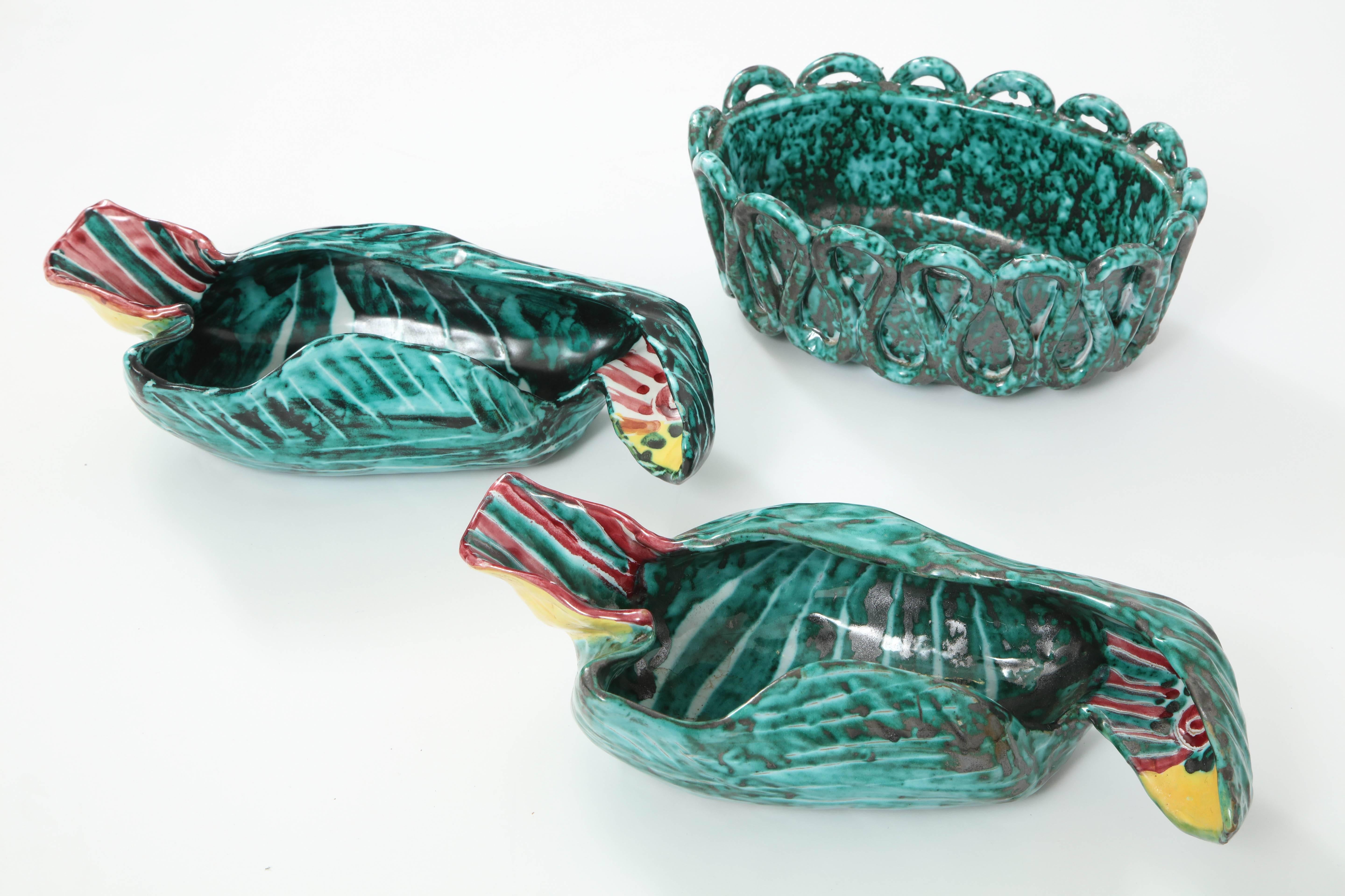 Fun pair of 1950s Italian ceramic hand painted parrots along with a Classic weave oval ceramic bowl. Period 1950s colors of aqua, green, maroon, and yellow with a nice artistic feel to them! Parrots have eyes at both ends! So one parrot can face one