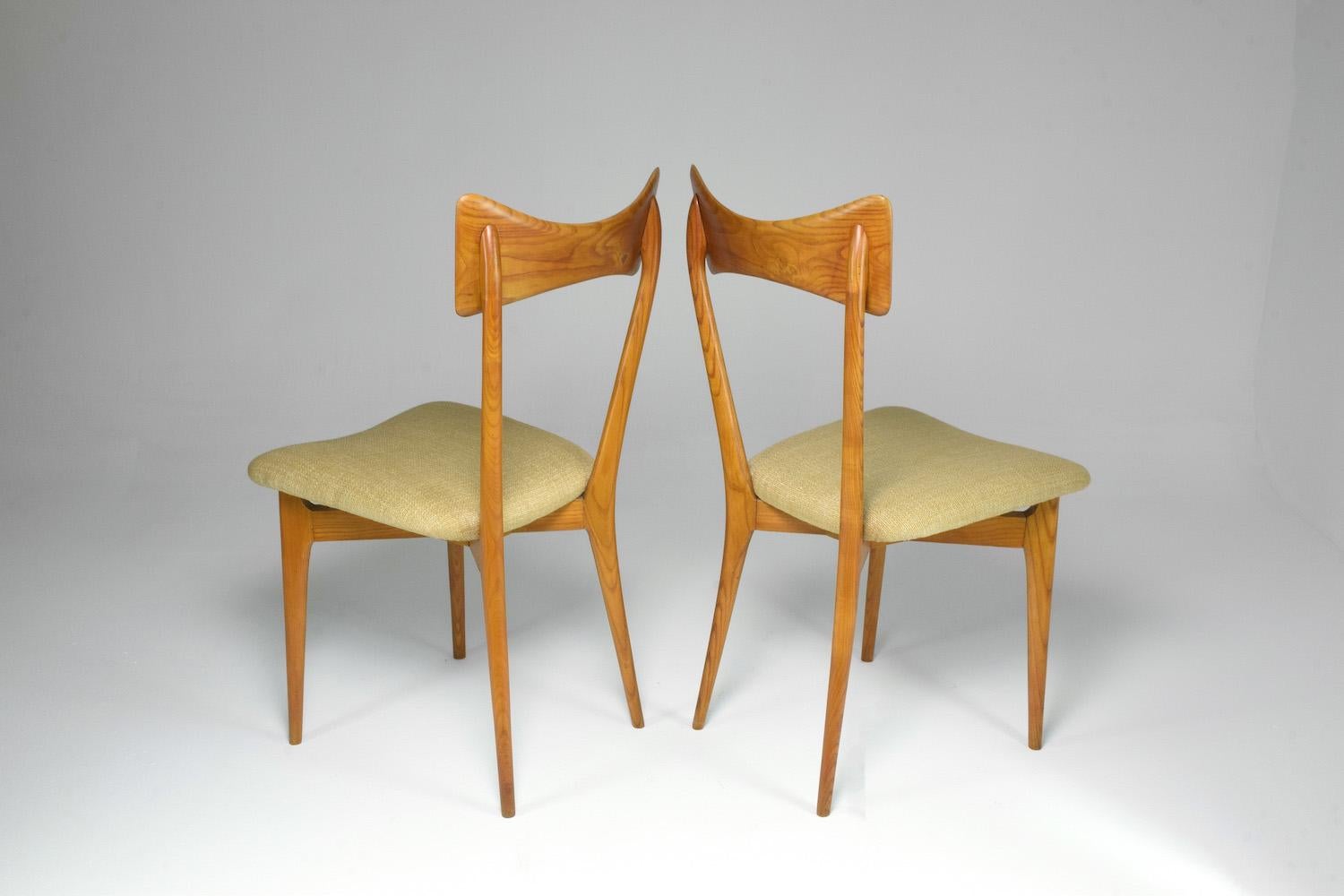 Two 20th century collectible chairs designed by the iconic duo Ico and Luisa Parisi for Ariberto Colombo in the mid-1950s. This classic design is highlighted by the curved backrest, splayed and tapered legs. 

In fully restored condition with a