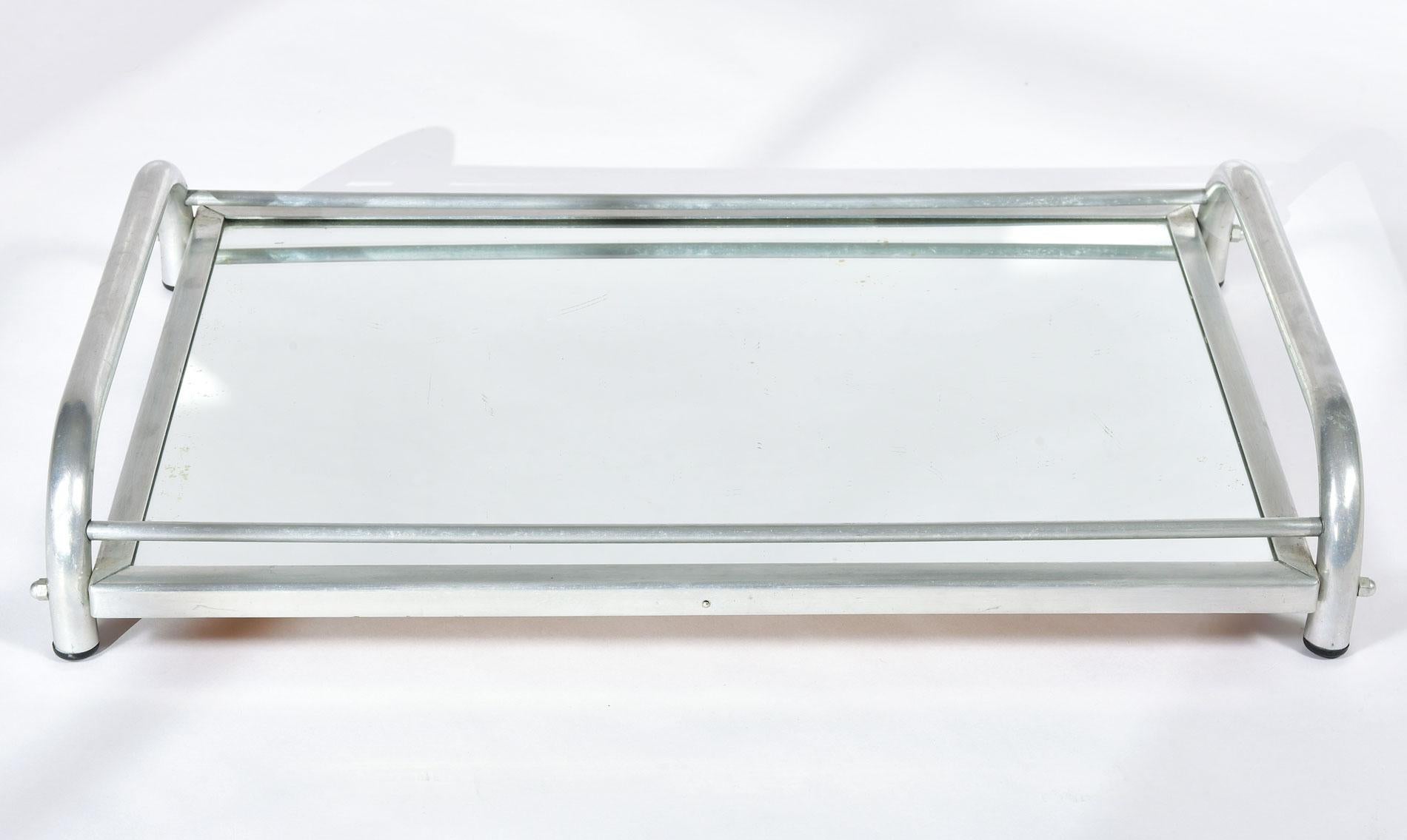 Chic mirrored tray in the style of Jacques Adnet. Simple tubular chrome handles with chrome frame and mirrored top.