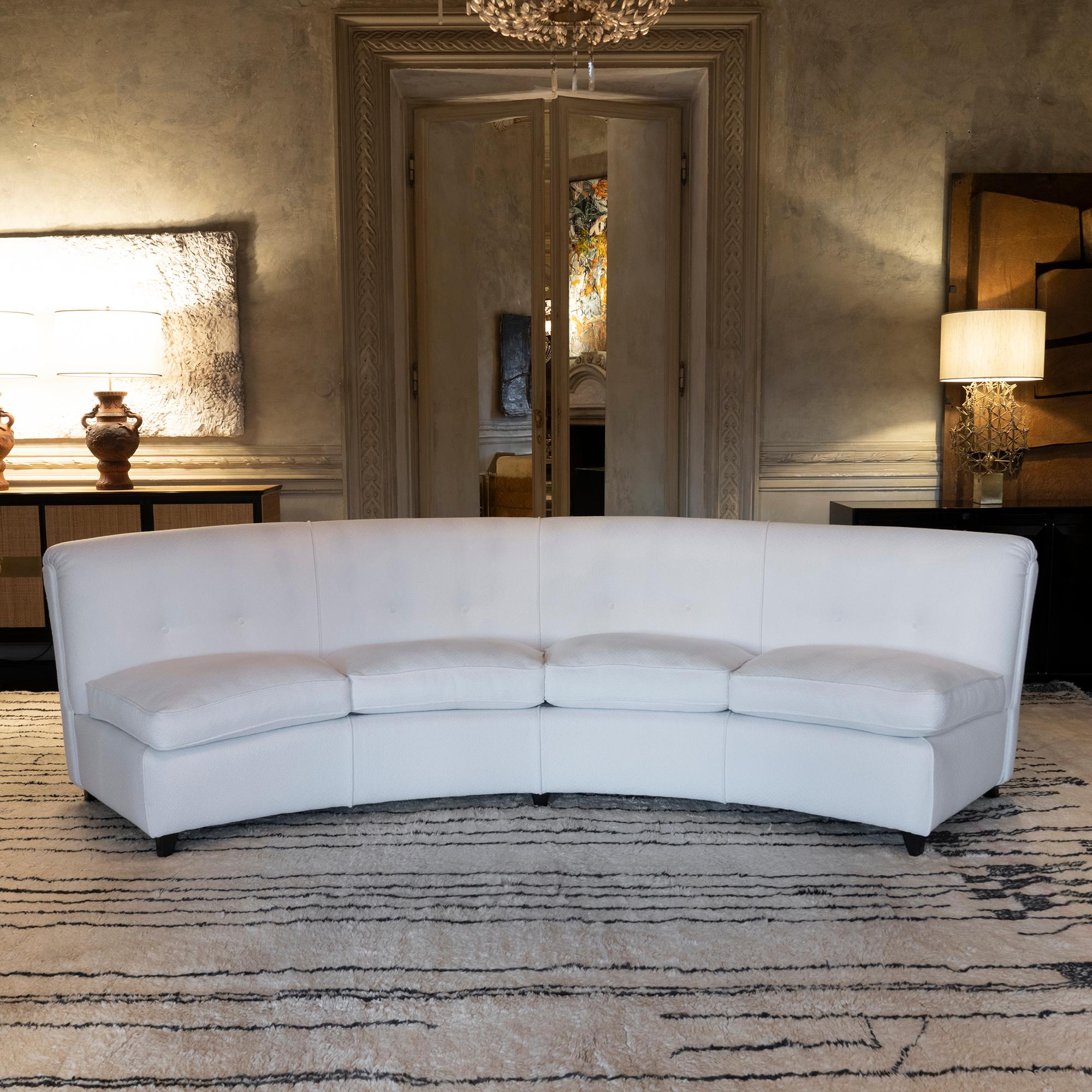 Curved sofa newly reupholstered in white woven jacquard fabric, seat cushions in goose feathers, details in black wood, Italy 1950's circa.