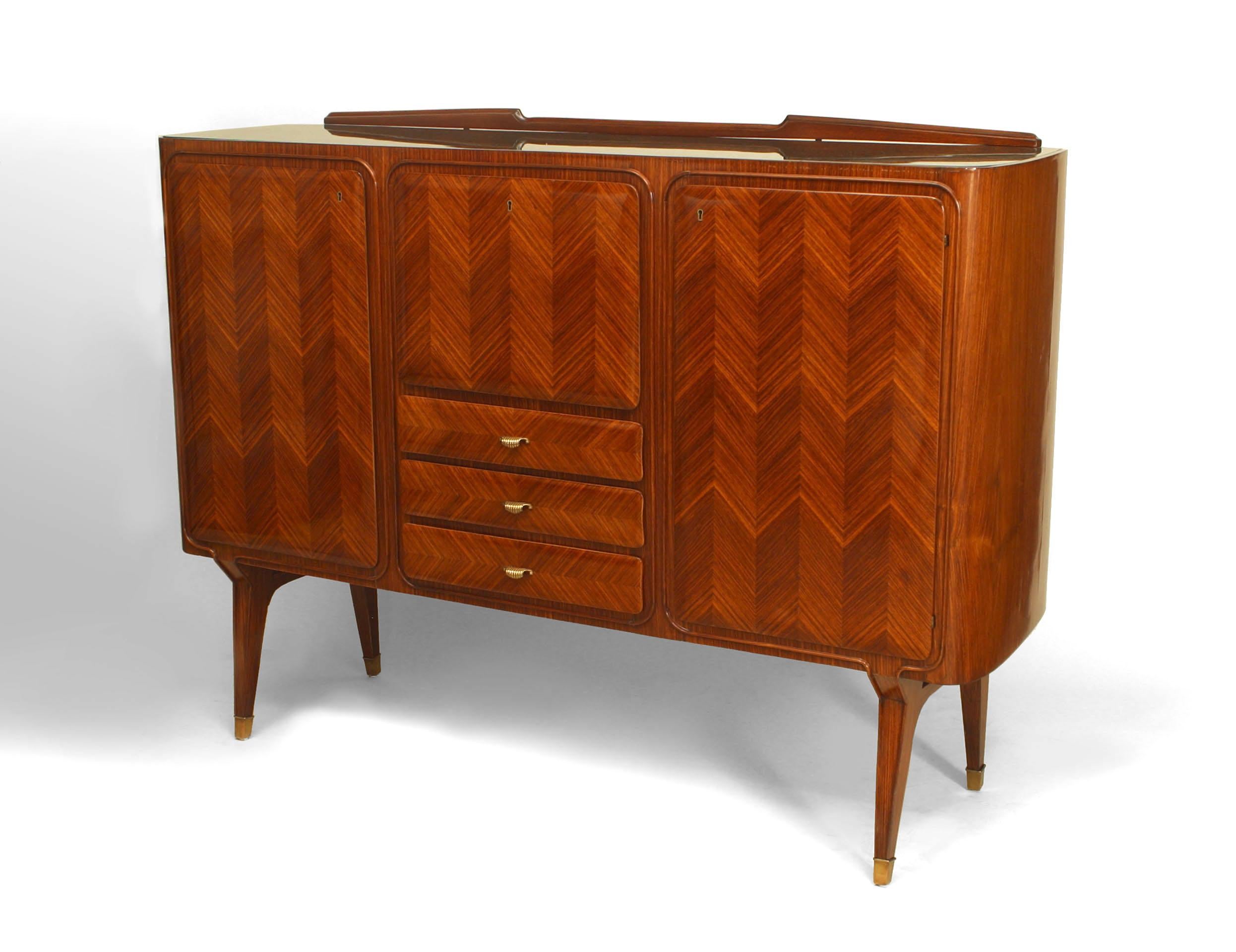 Italian Mid-Century (1950s) rosewood sideboard with herringbone design veneer with 2 side doors flanking a drop down door over 3 drawers with a low backrail and green glass top (DASSI)
