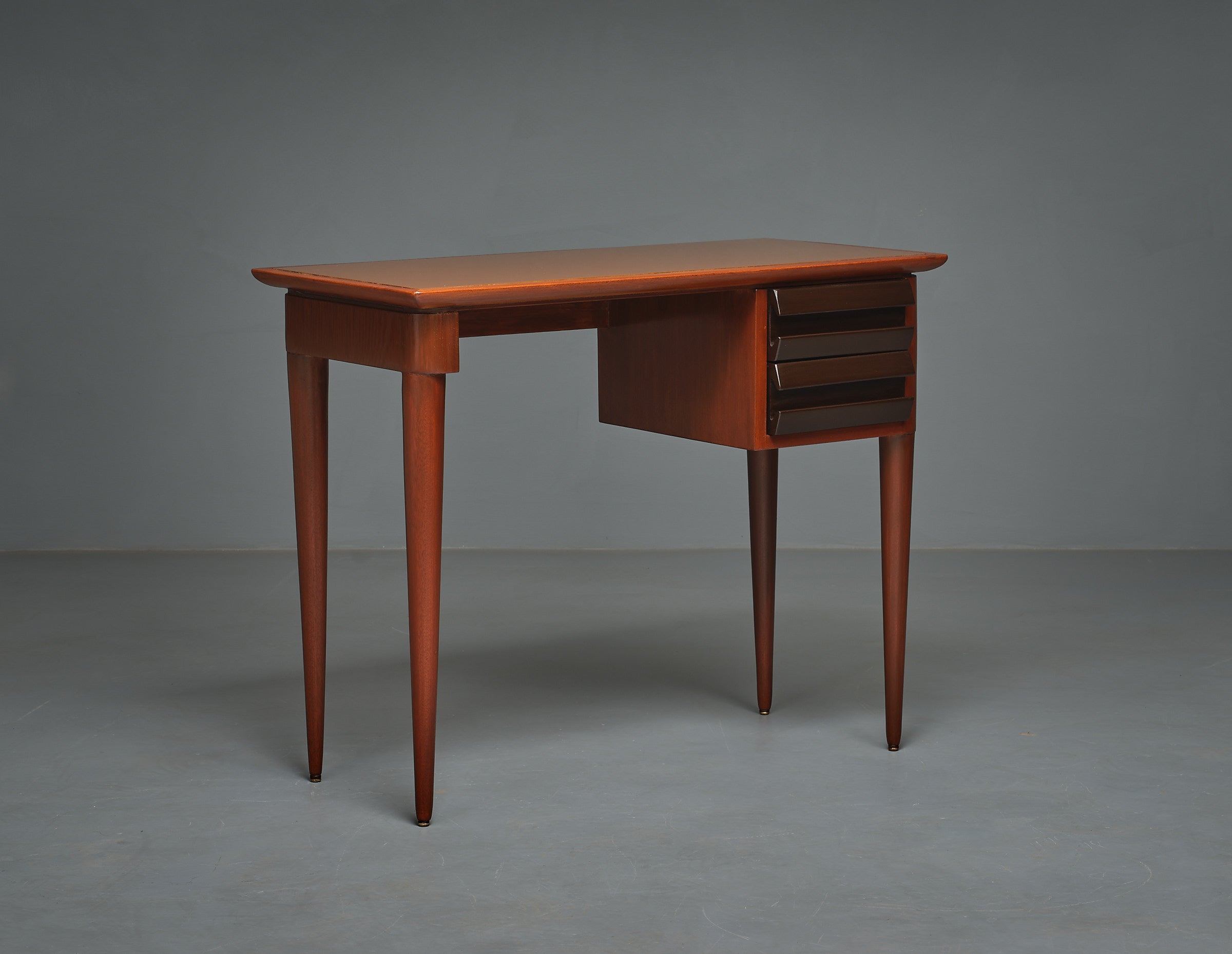 Presenting a  1950s Italian desk, a masterpiece of modern design attributed to Vittorio Dassi. Crafted with precision in high-quality Italian cabinetry, this desk seamlessly blends the sophistication of Italian craftsmanship with a sleek, modern
