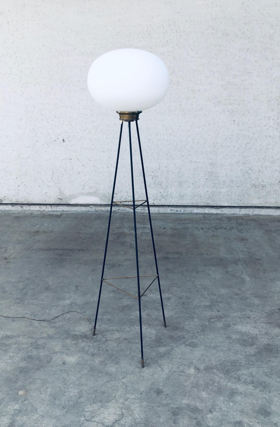 Vintage Midcentury Modern Italian Design in the manner of Stilnovo Tripod Floor Lamp. Made in Italy, 1950's. Brass and lacquer tripod base with white opaline ball shade. This fragile minimalistic designed lamp gives a nice soft glow. A rare lamp in
