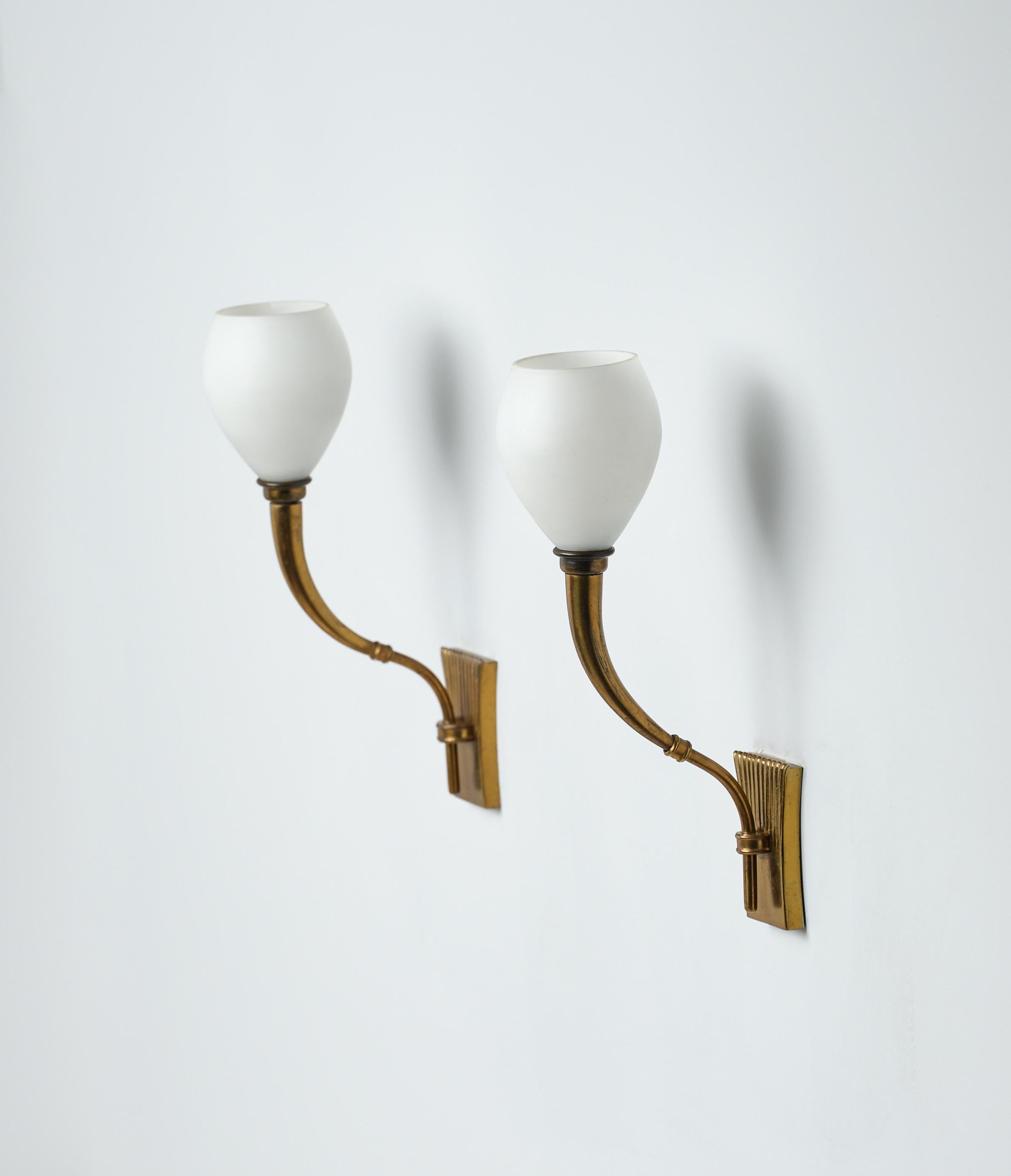 Discover timeless elegance from our collection of vintage Italian wall lamps of the 1950s. These rare and precious pieces, attributed to the renowned 'Fontana Arte,' showcase exquisite design in brass and opaline glass. Each lamp exudes