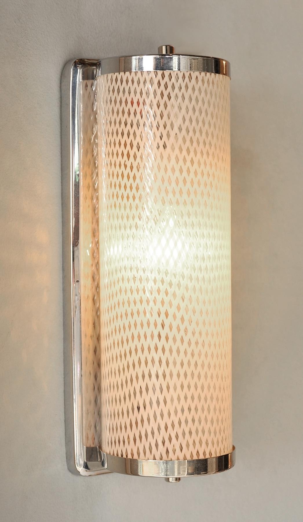 Italian wall lights with chrome brackets holding vertical Murano glass shades with 'lattice' design.