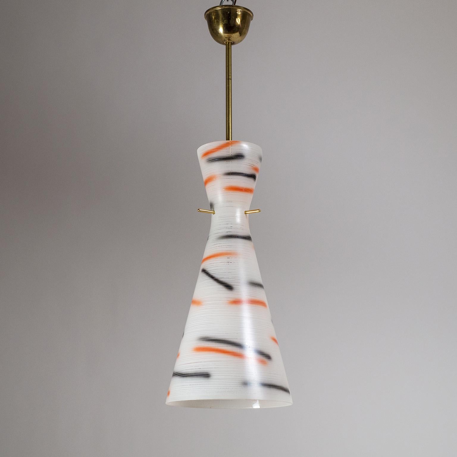 Highly unique and unusual midcentury Italian glass pendant. The large double cone glass diffuser is enameled in white with red and black sprayed streaks and has fine spiraling incisions, a very bold and gestural Avant Garde design. Good original