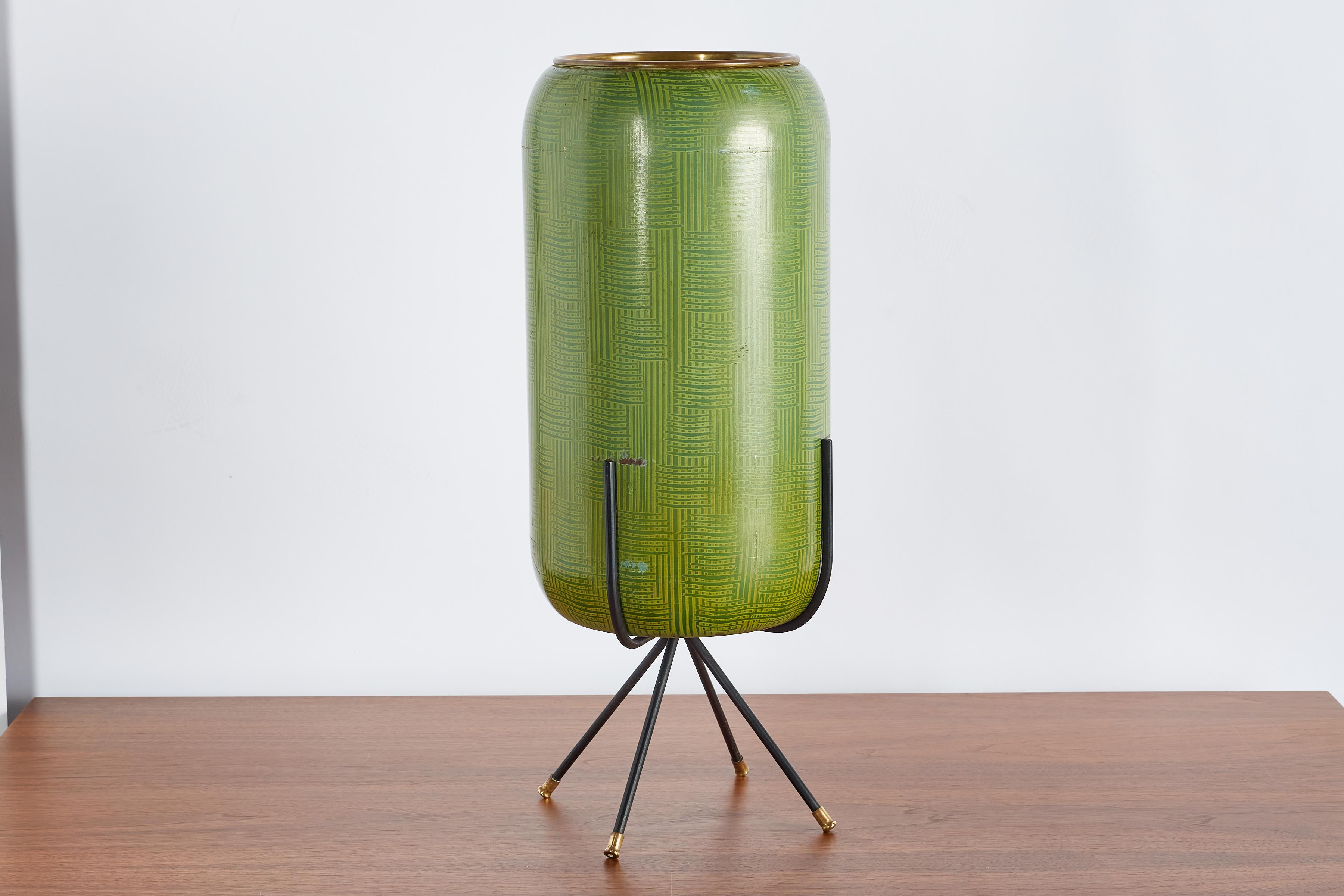 Unique cylindrical umbrella stand in enameled green with geometric pattern. 

Iron tripod base with brass feet and brass rim. 

Italy, 1950s


