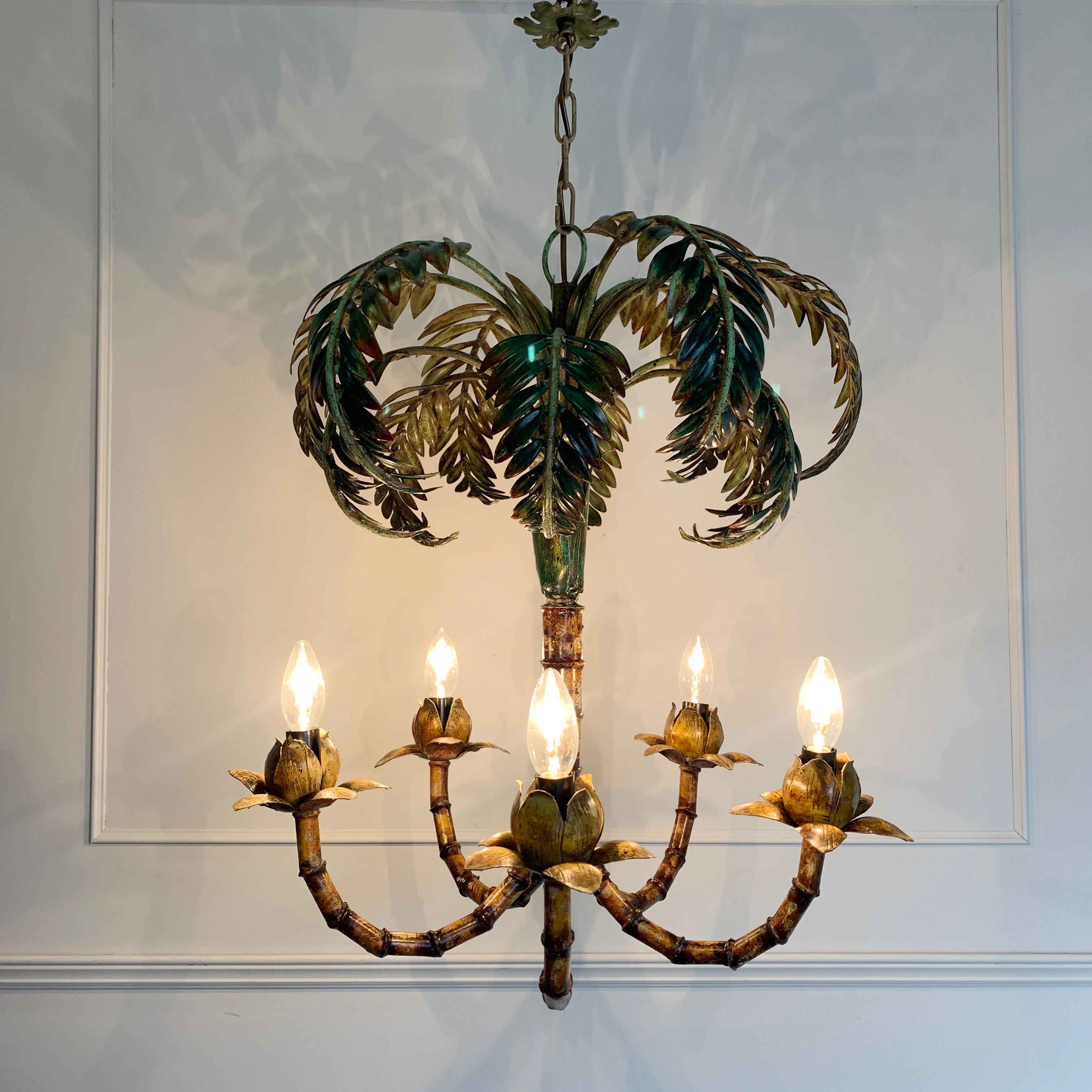 Faux bamboo palm tree chandelier
1950s, Italy
Stunning large faux bamboo palm tree tole chandelier
Fabulous original hand painted color and detailing
5 arms with single bulb holder to each, E14 small screw in bulbs
Original chain and metal ceiling
