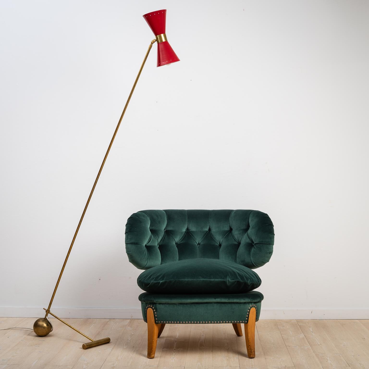 Italian floor brass lamp Stilnovo. The lamp was manufactured in Italy during the late 1950's. The frame is of brass and the shade has red lacquer. The foot switch as well as the electrical wire are original to the lamp. The natural patina of the