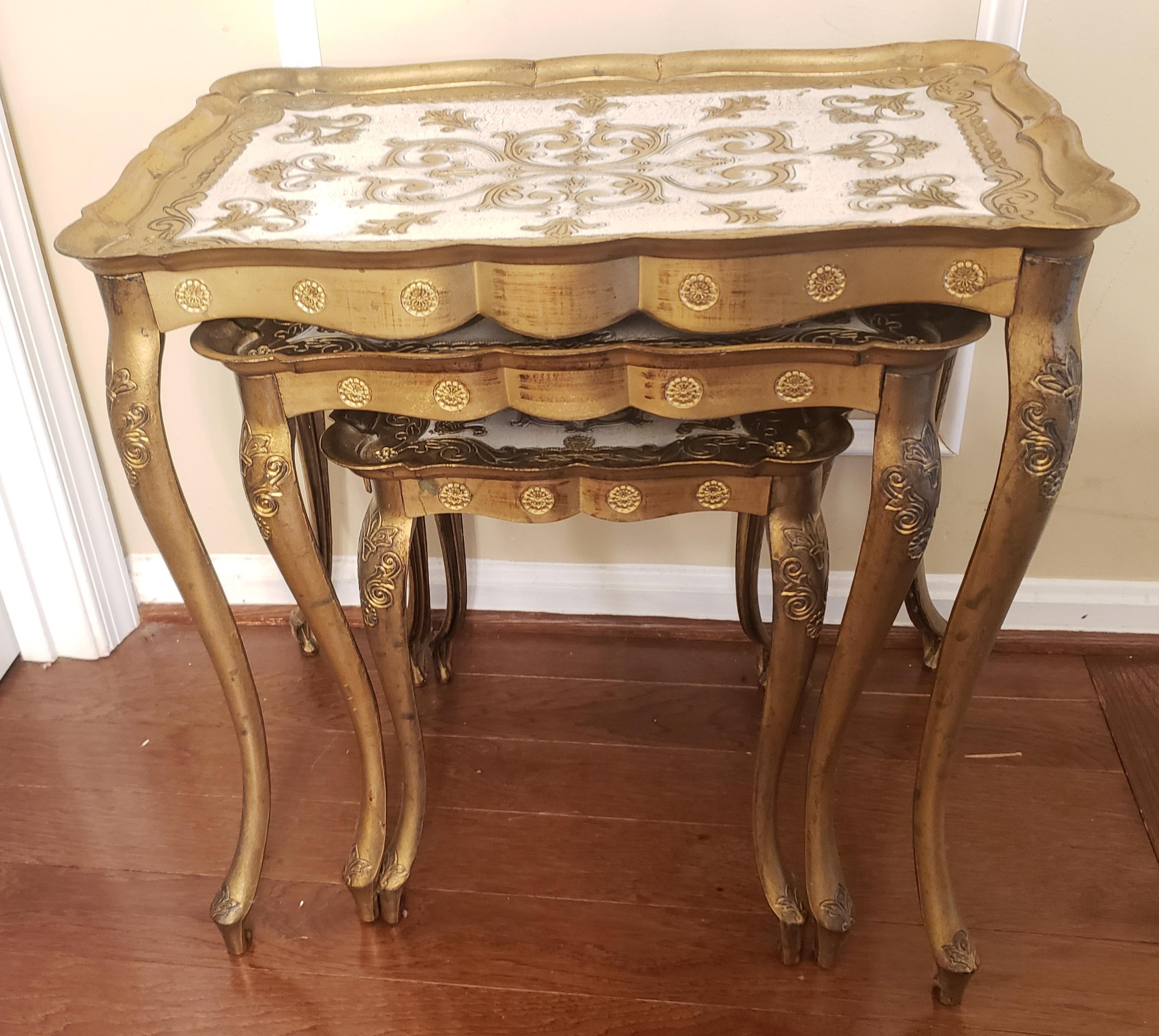 Mid-century Italian Florentine Nesting tables are ideal for cozy living spaces, where a nicely proportioned end table is desired, yet two more smaller end tables are immediately available should the occasion demand it. Finished in a lovely gold with