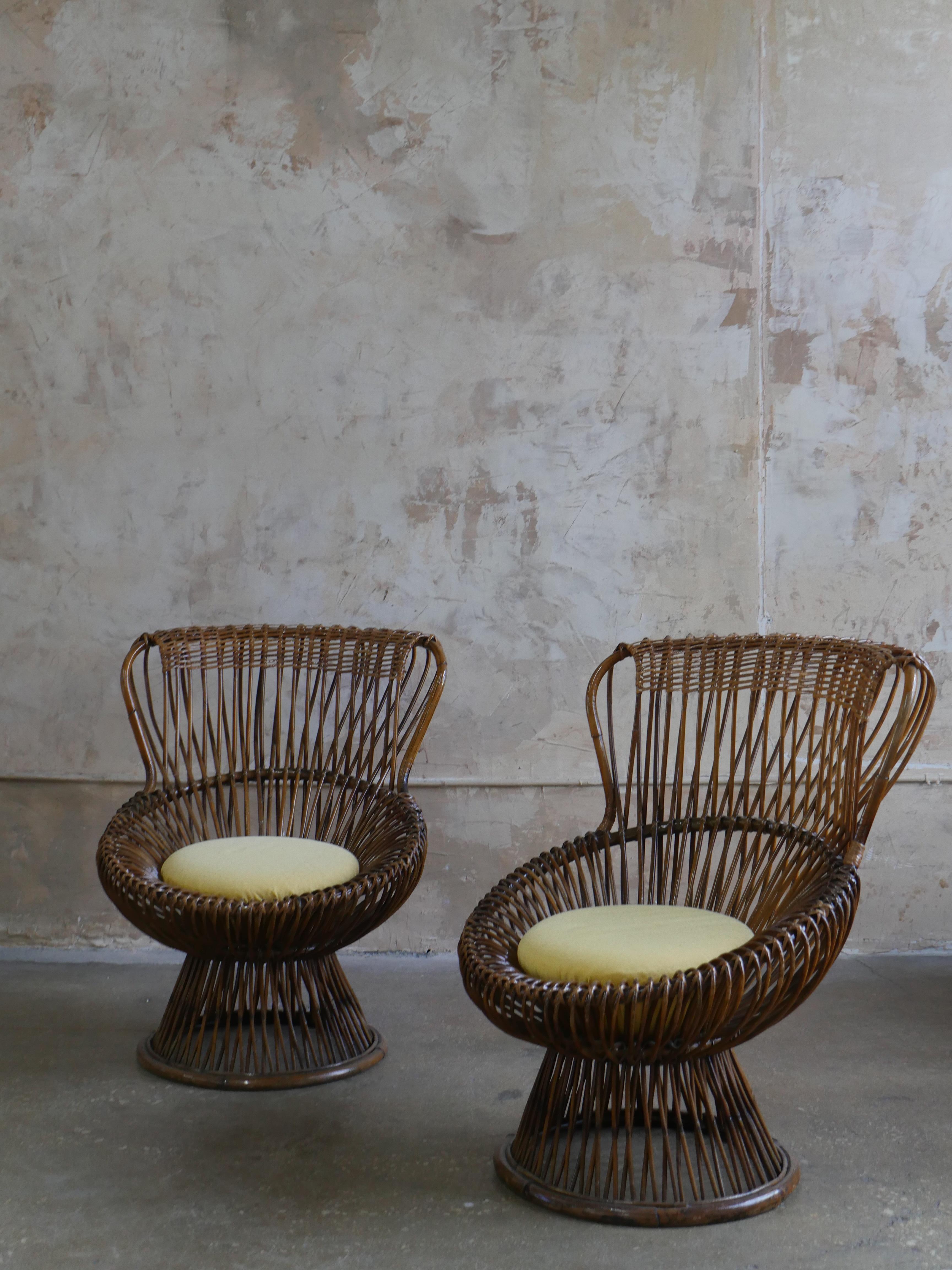 An iconic pair of “Margherita” rattan armchairs, designed in the 1950s by Italian modernist Franco Albini for Bonacina. A pioneering blend of traditional craftsmanship and modernist form, these sculptural chairs feature wide, organic silhouettes