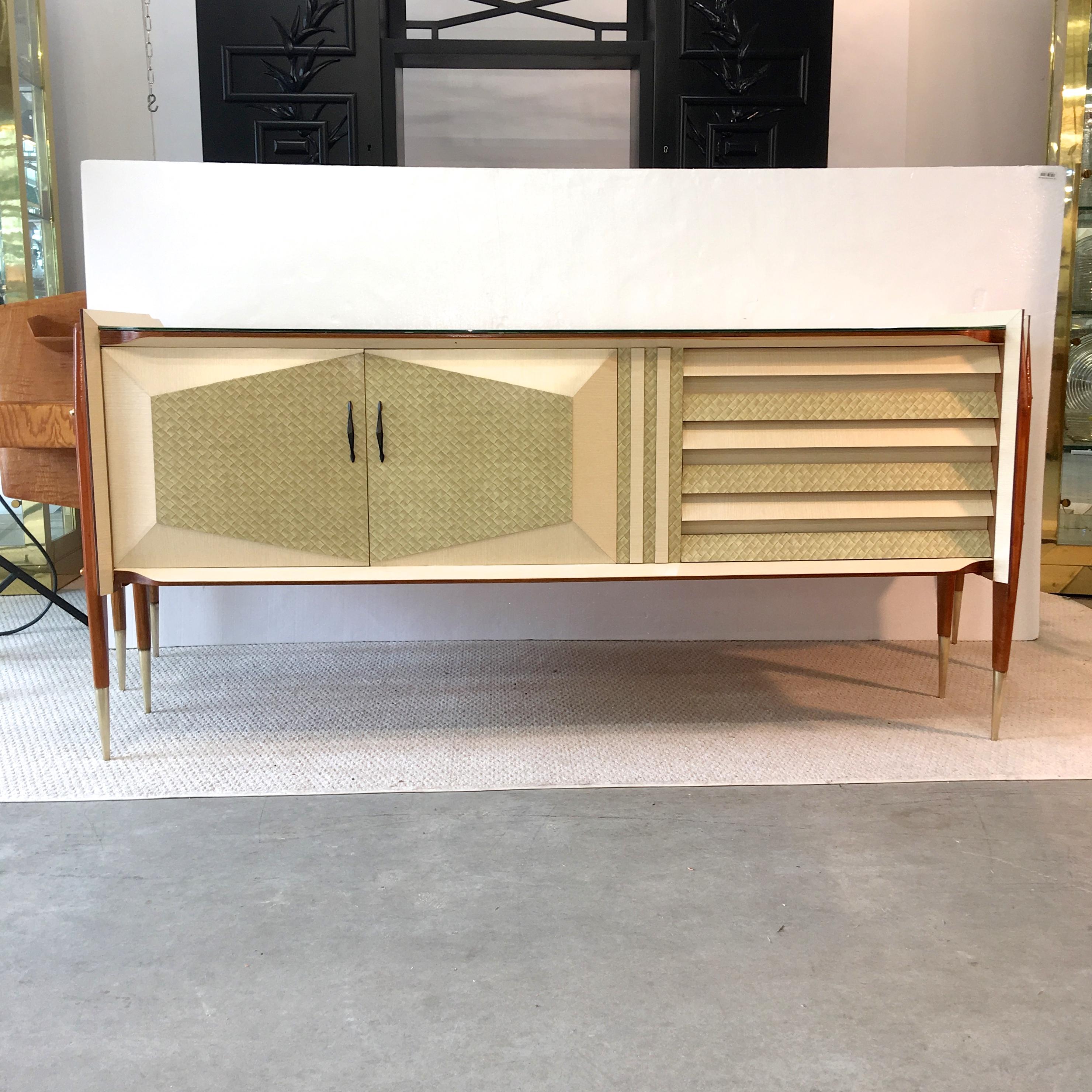 Incredible unicorn! Rare 1950s Italian sideboard with reverse painted marbleized glass top case with geometric faceted door panels and drawer fronts floating suspended by four exoskeletal wood legs with solid brass standoffs, acorn nuts and tapered