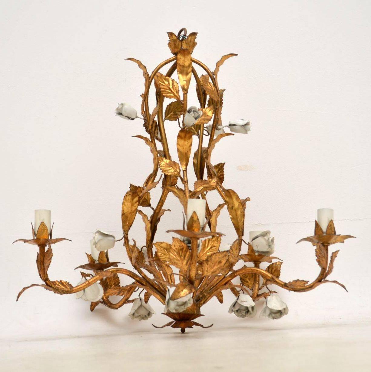 An absolutely stunning vintage chandelier in gilt metal, this was made in Italy and it dates from around the 1950s-1960s. It’s of amazing quality with a beautiful floral design. The rose buds are painted white, and the condition is excellent for its