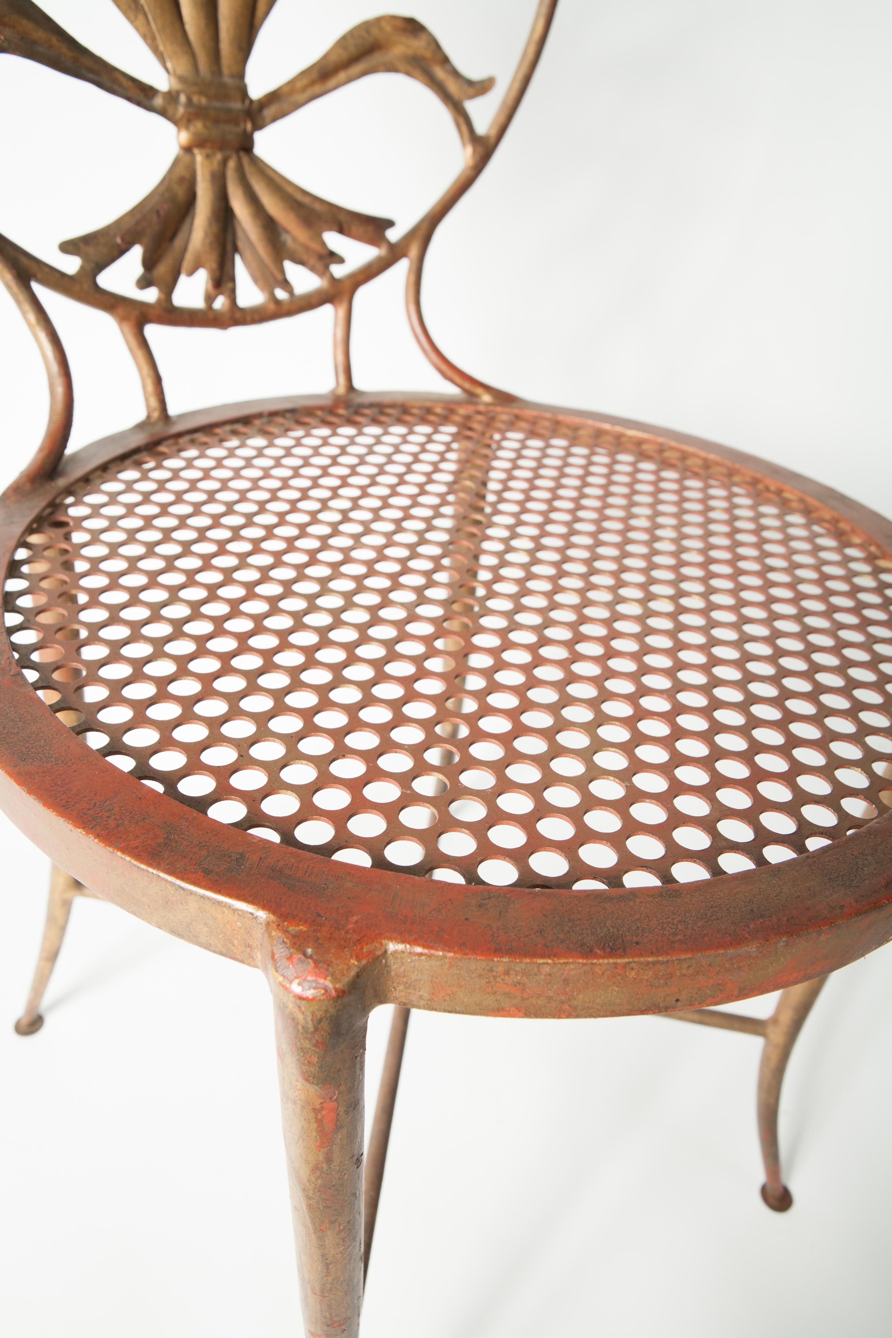 Beautifully patinated pair of metal Italian side chairs with wheat motif to the back. Sturdy and beautiful pair.
